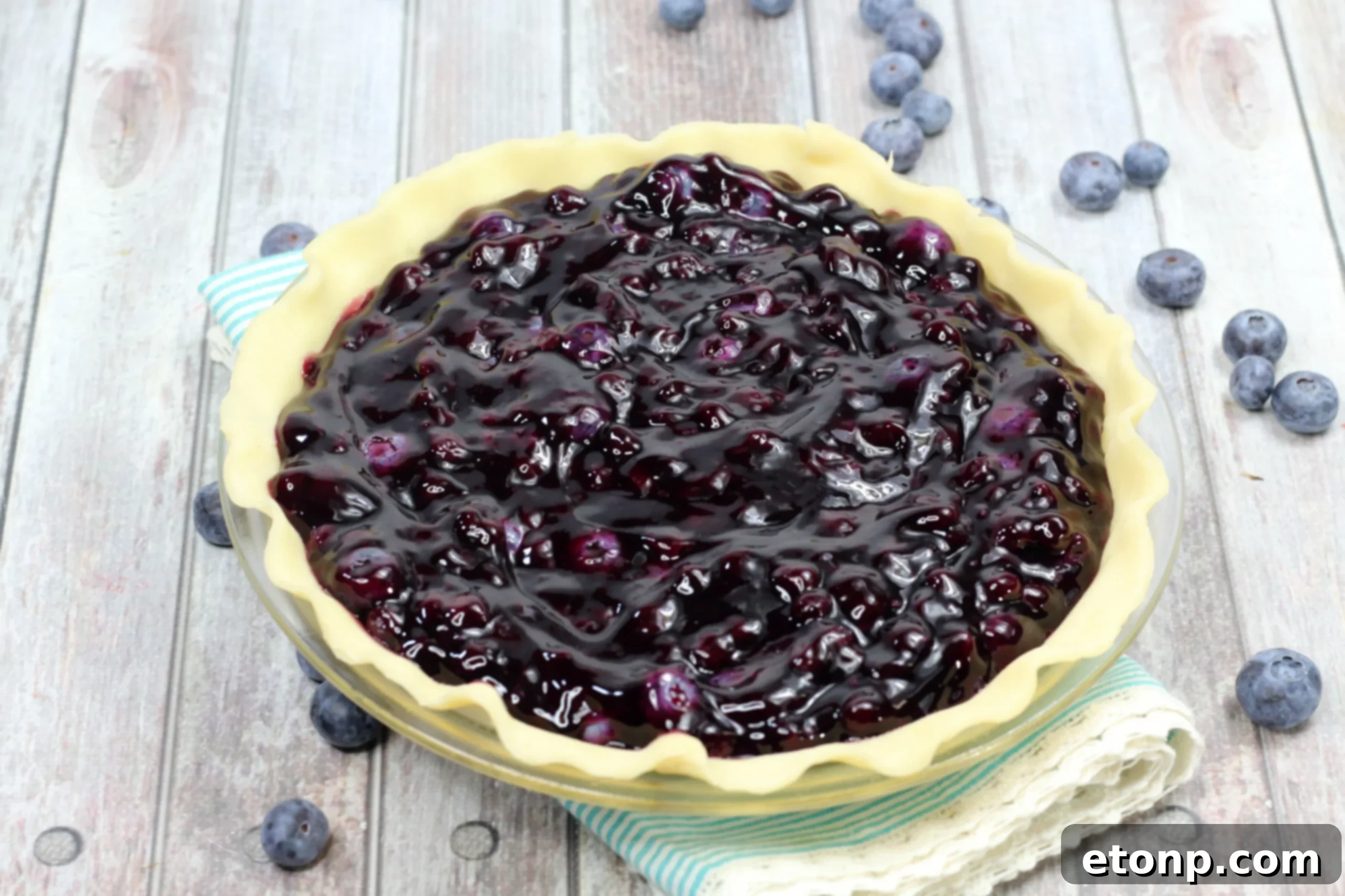 Close-up of the thick, sweet blueberry pie filling, ready for the crust