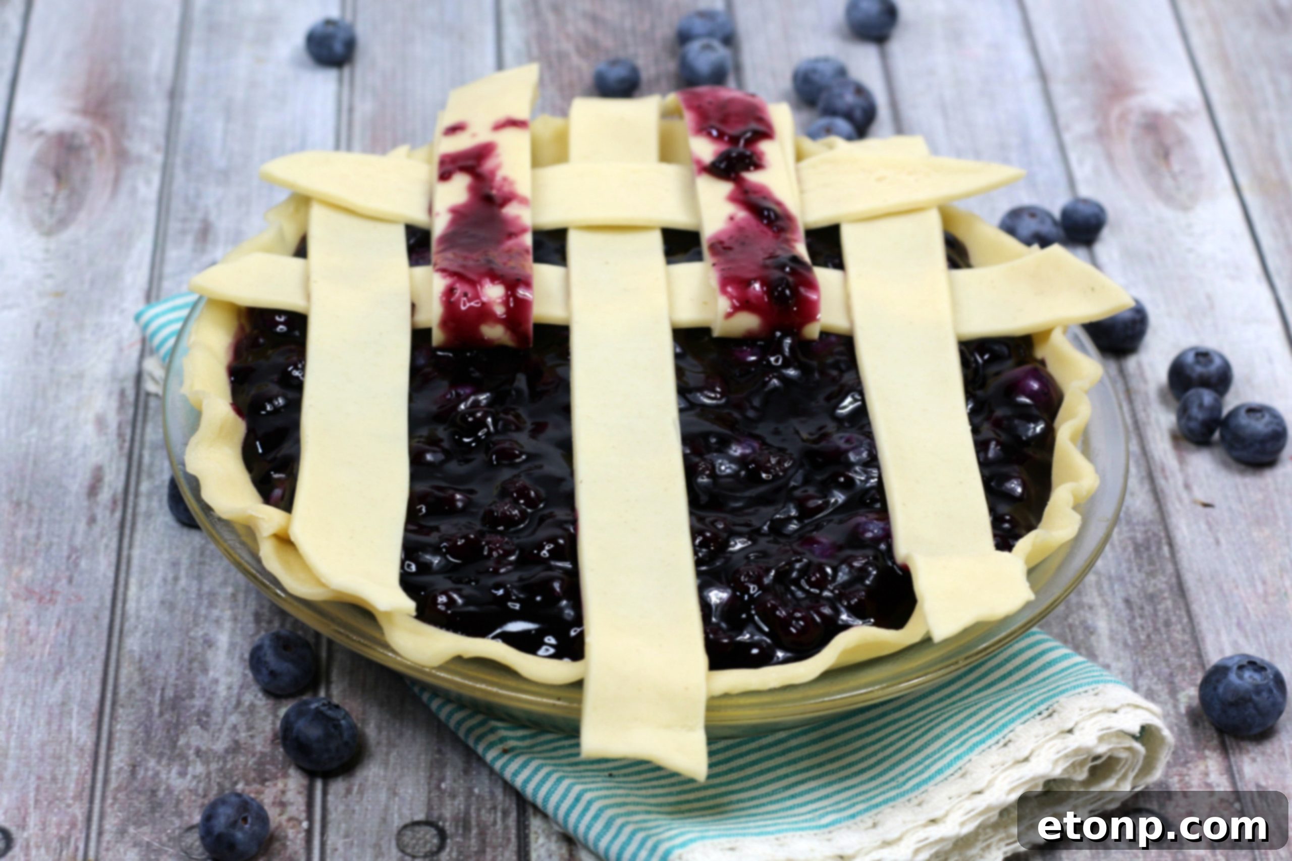 A whole blueberry pie showcasing its delicious filling and crust