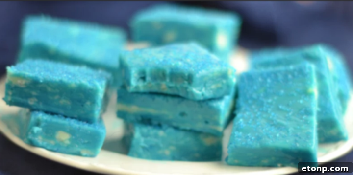 Close-up of sparkling blue fudge pieces with colorful sprinkles, ideal for a Frozen-themed celebration