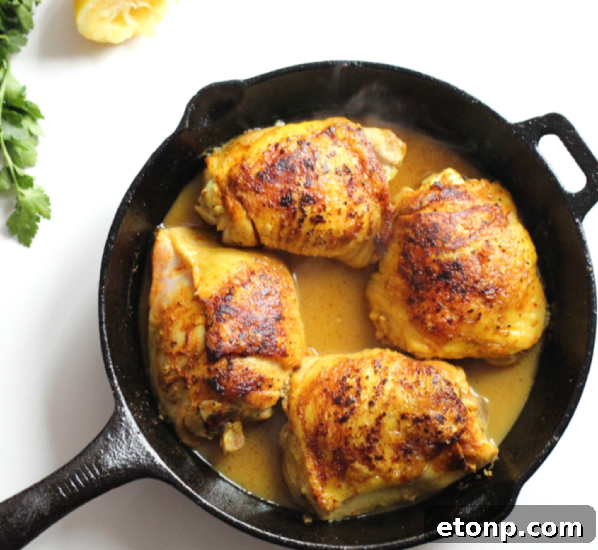 Sticky Sweet Lemon Chicken Skillet 4 Brown sugar lemon chicken skillet simmering on the stovetop, with vibrant green parsley garnish.