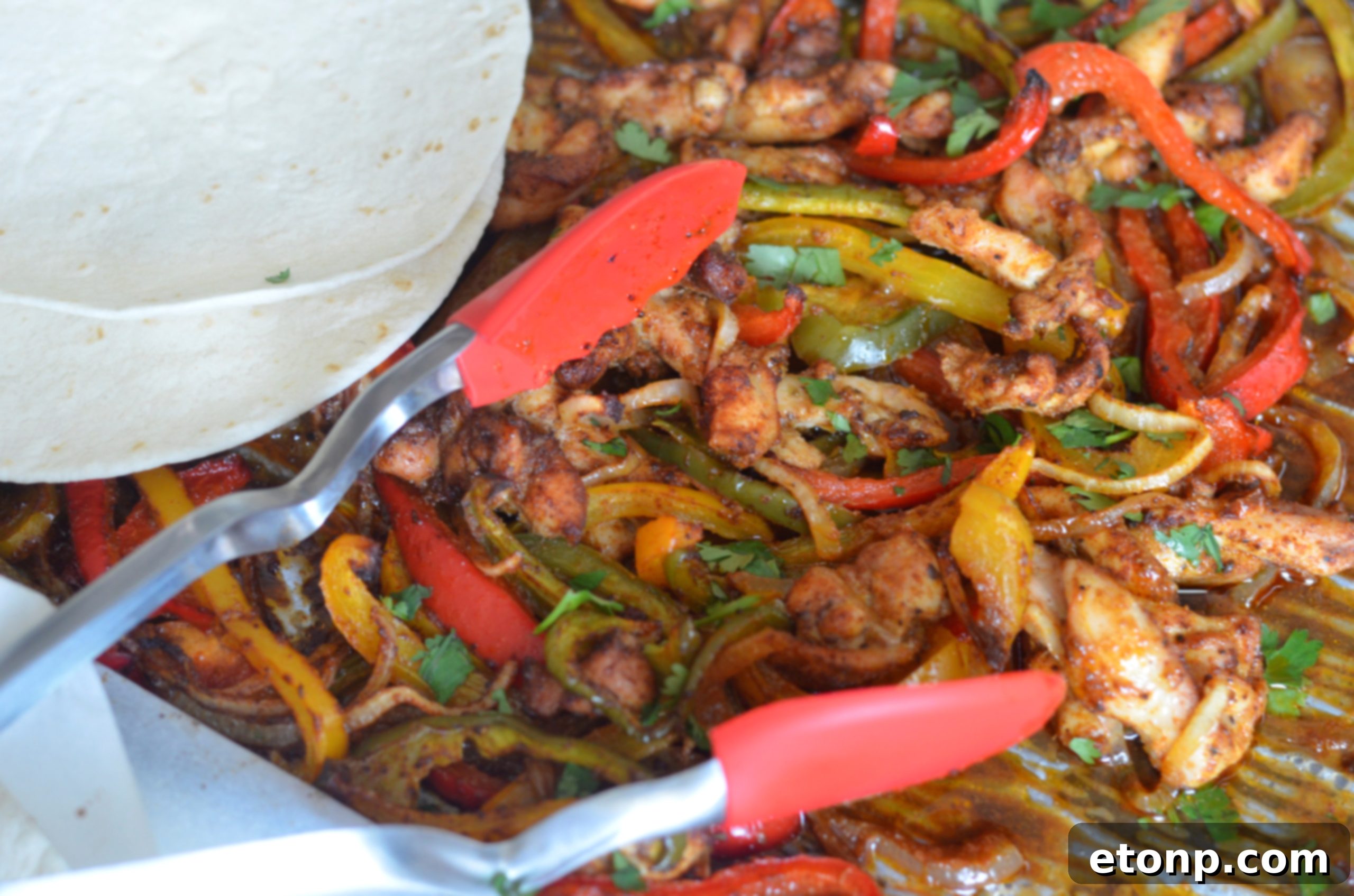 A delicious close-up of a single chicken fajita wrapped in a warm tortilla, showcasing the tender chicken and colorful peppers.