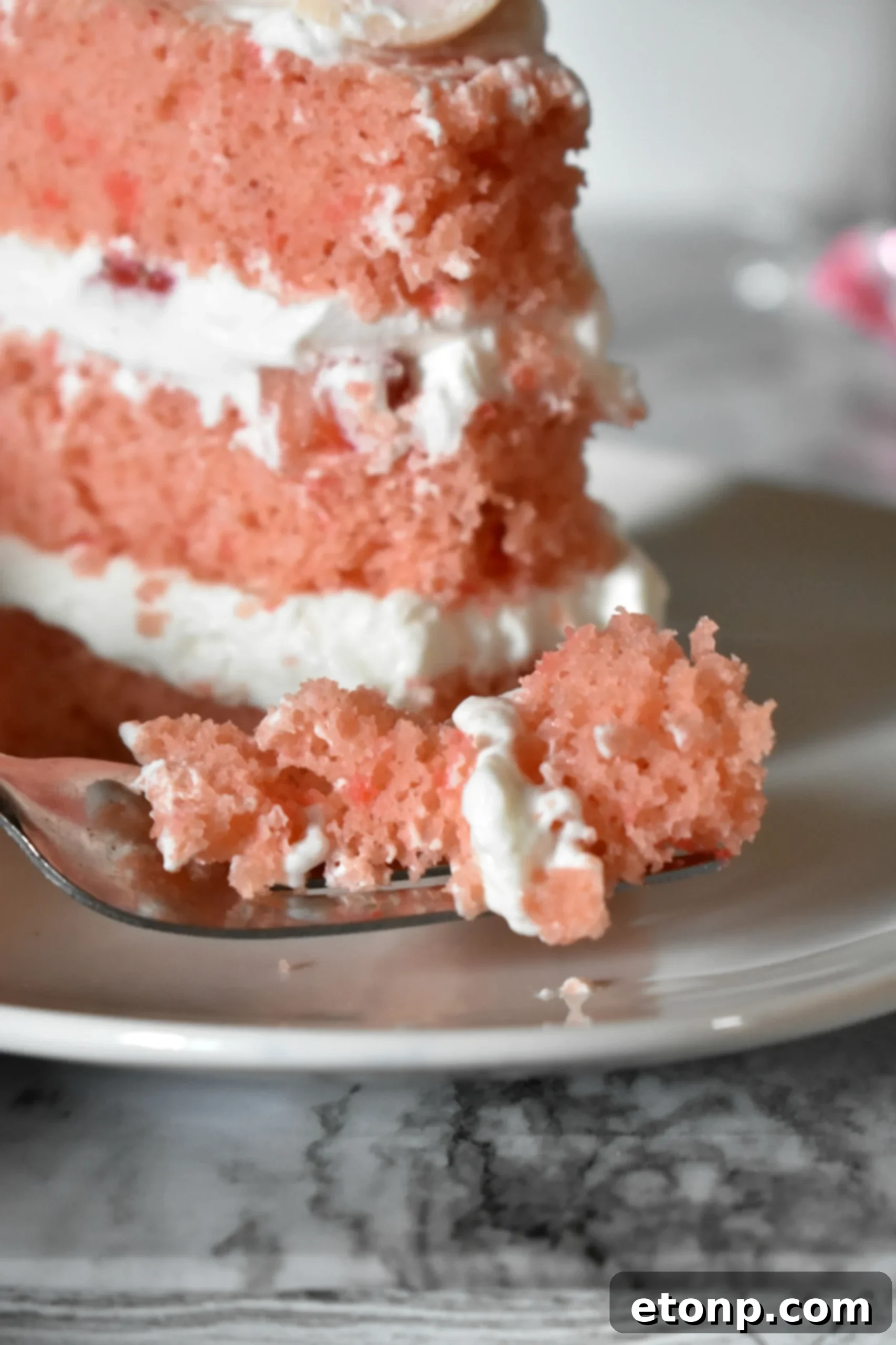 A close-up of the creamy, delicate whipped frosting on the Strawberry Creamsicle Layered Cake.