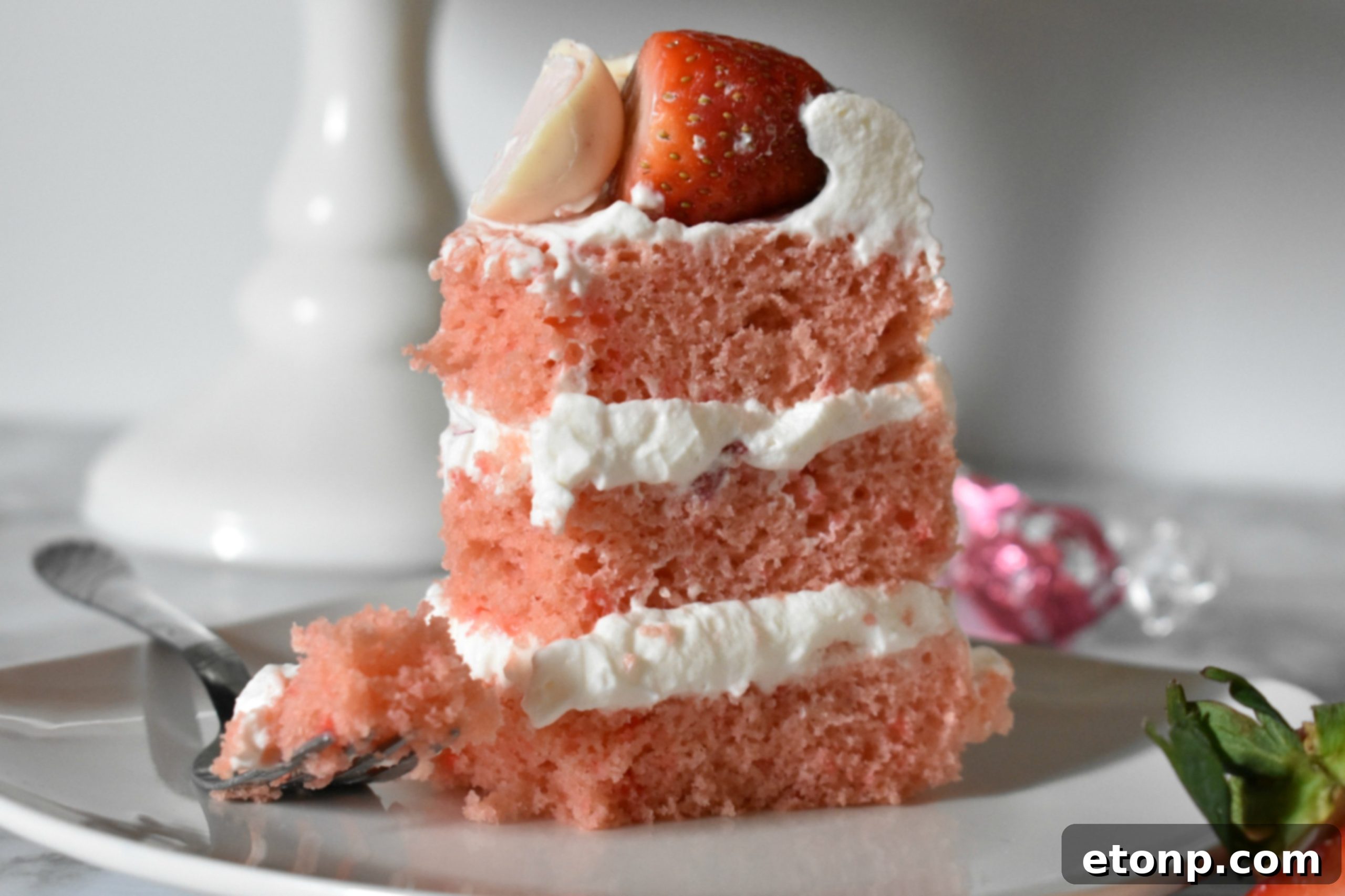 Side view of a beautifully frosted Strawberry Creamsicle Layered Cake, ready to be served.