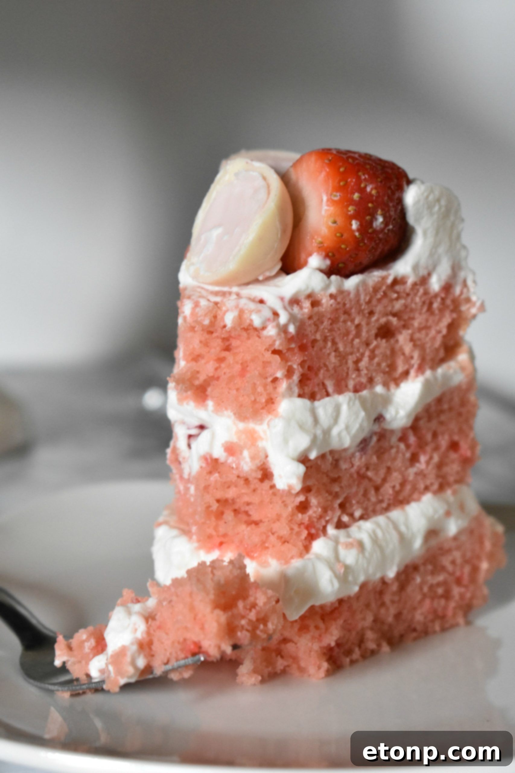 A final close-up of the Strawberry Creamsicle Layered Cake, decorated with fresh strawberries and chocolate truffles, emphasizing its delectable appeal.