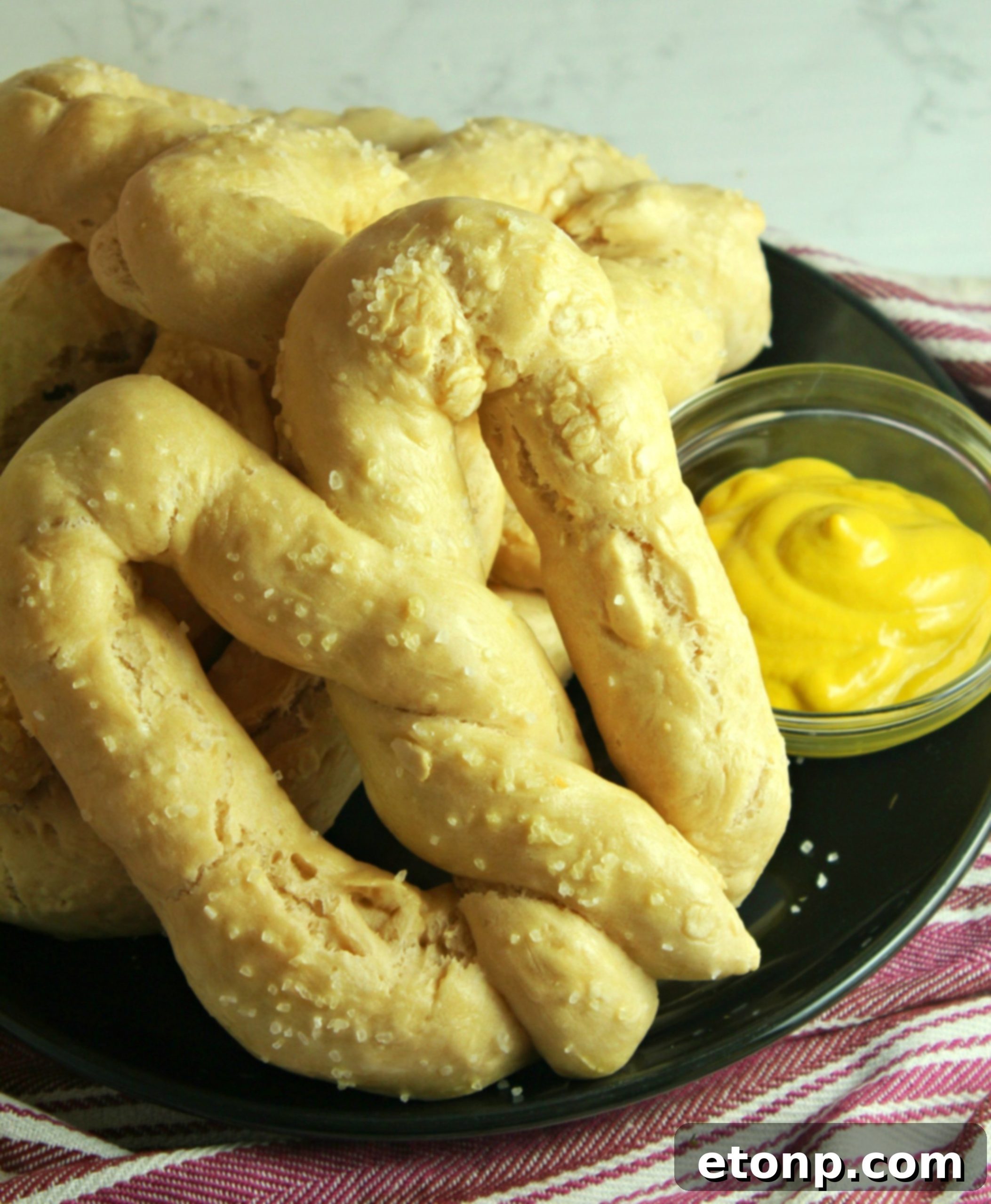 Freshly baked homemade soft pretzels, golden brown and ready to dip.