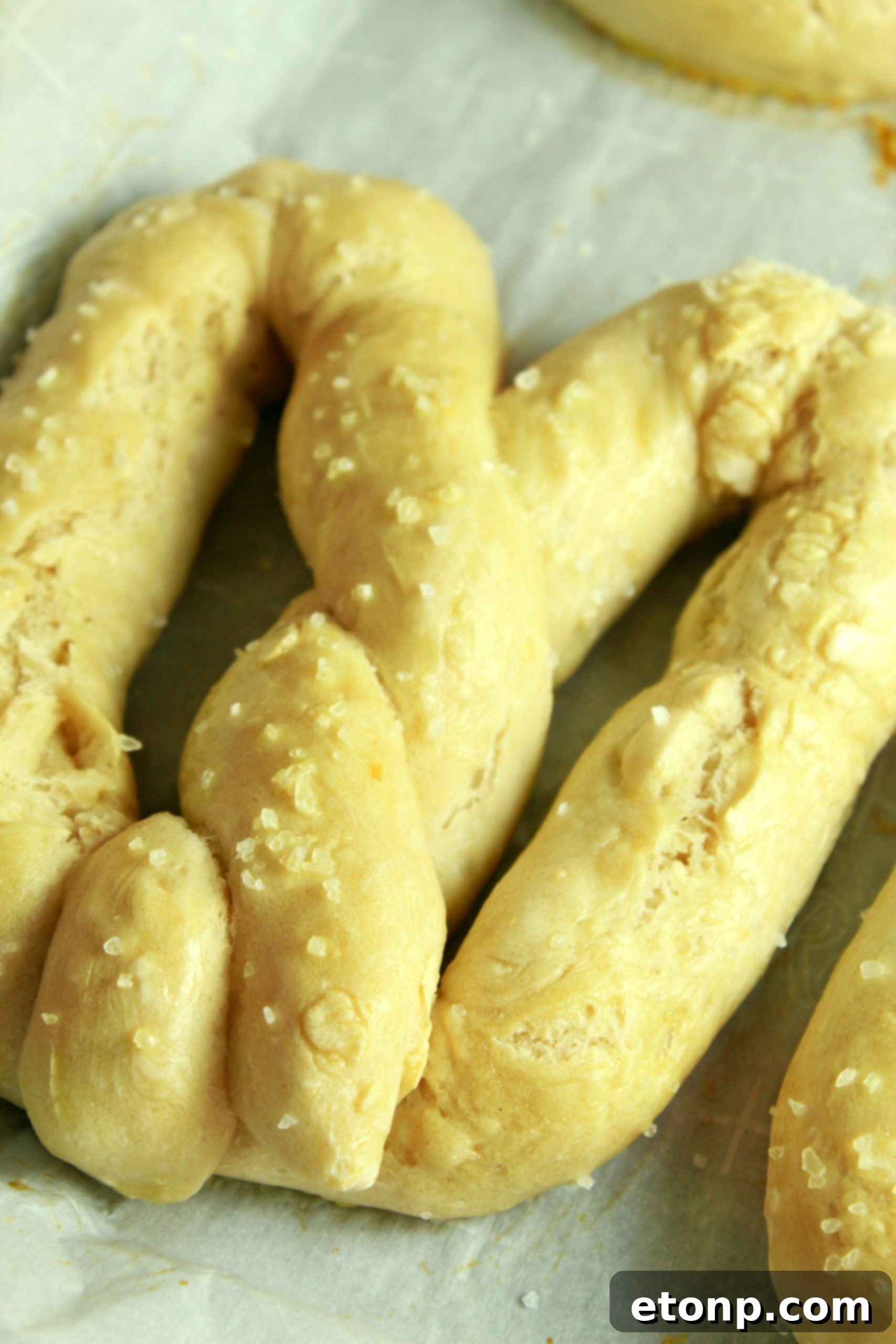 Assorted dipping sauces displayed next to freshly baked soft pretzels.