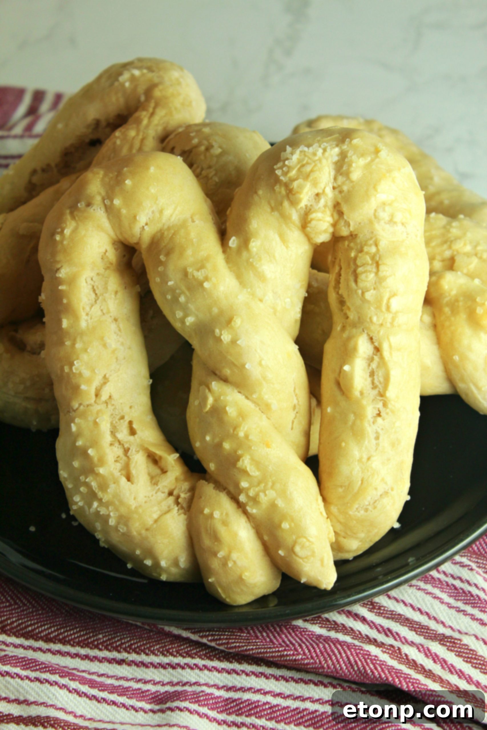 Homemade soft pretzels cooling on a wire rack, ready to be enjoyed.