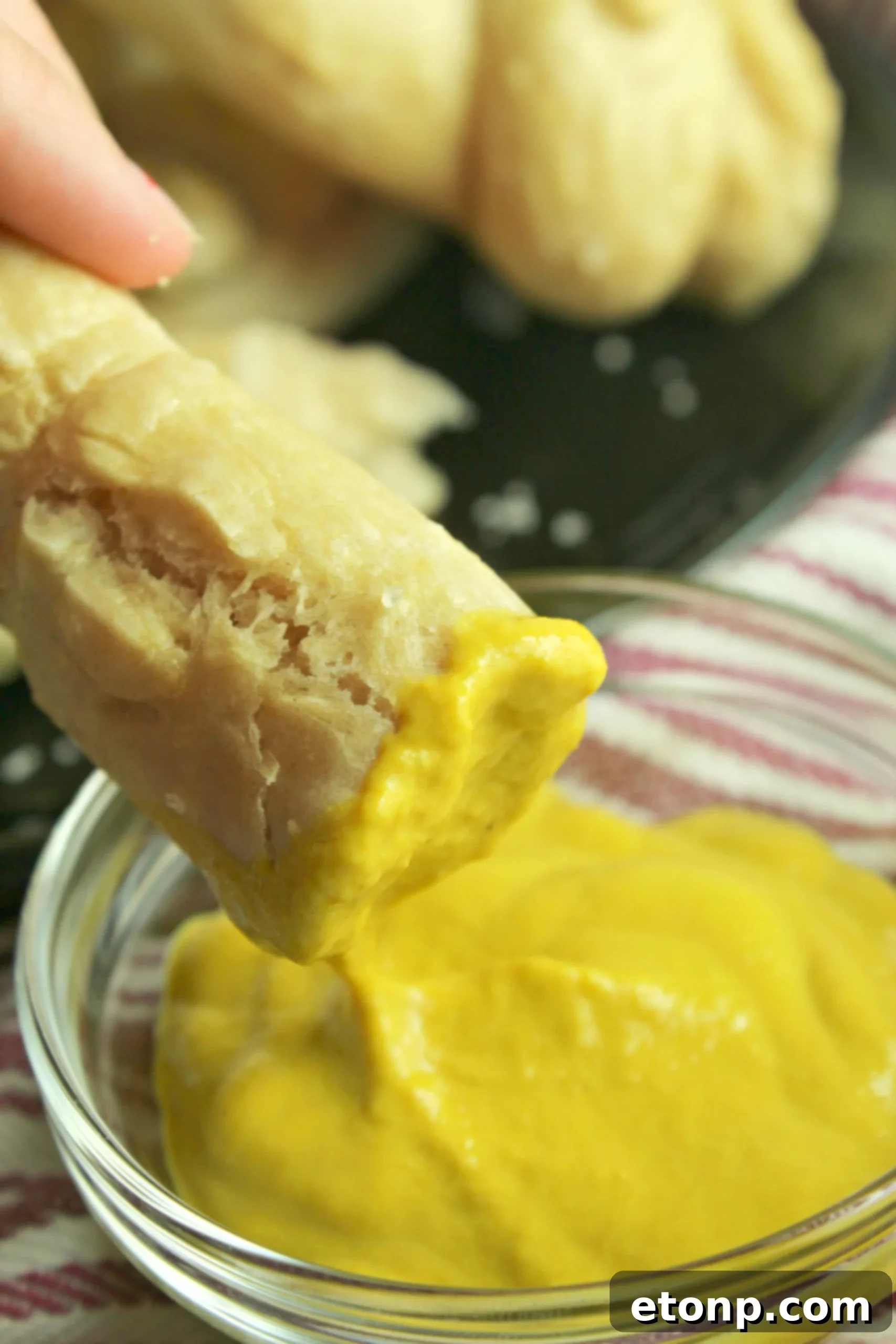 Detailed shot of a soft pretzel with coarse salt, showcasing its texture.