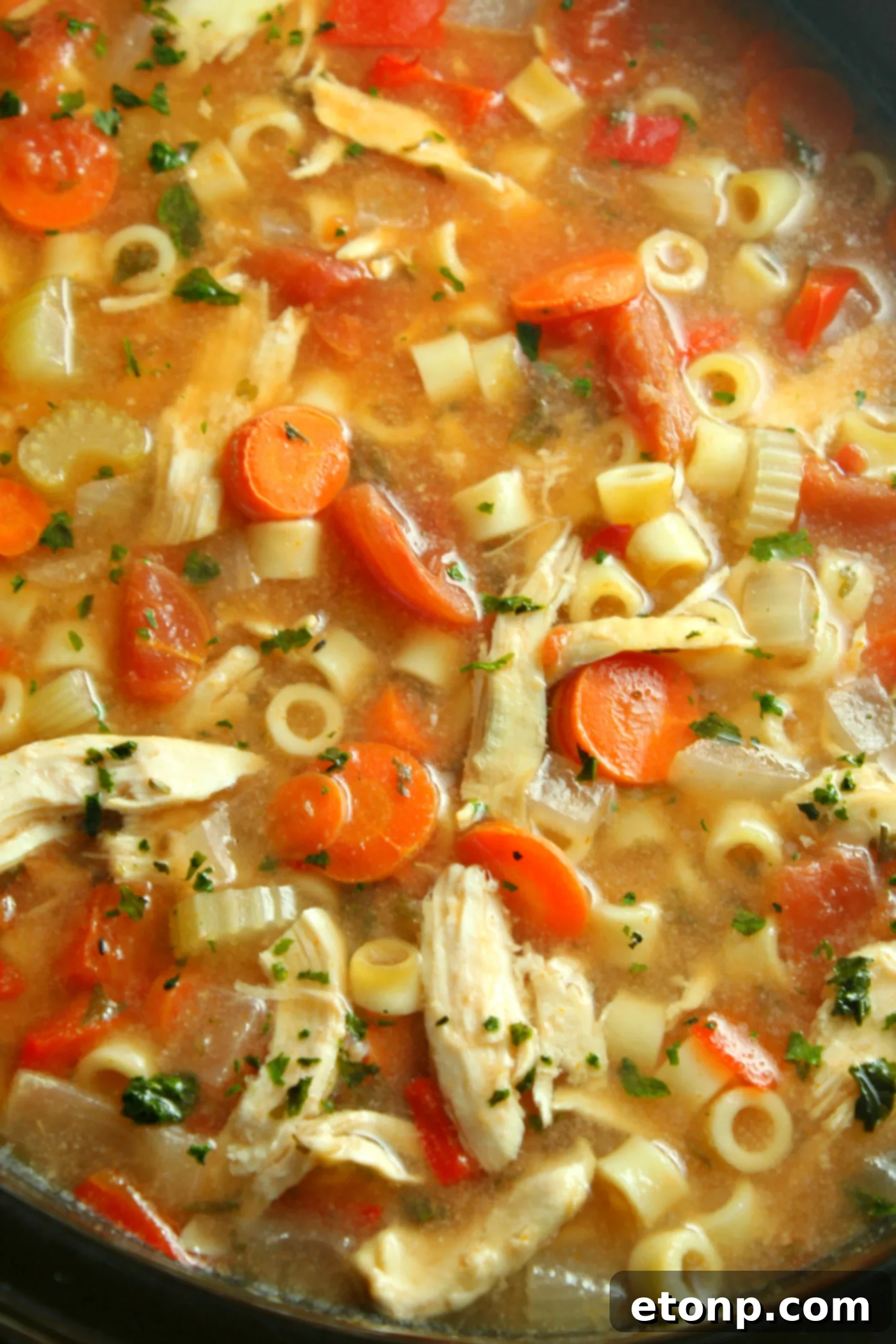 Overhead view of a large ceramic pot filled with freshly made Sicilian Chicken Soup