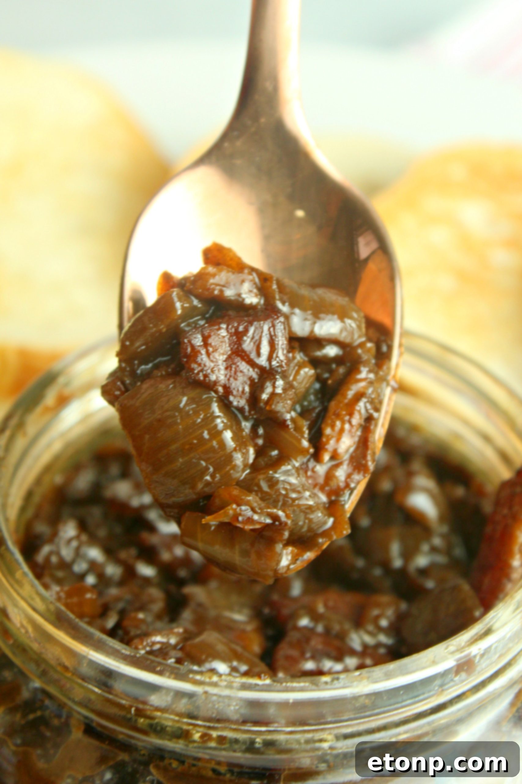 A serving of bacon jam in a small white bowl, ready to be enjoyed or paired with a meal