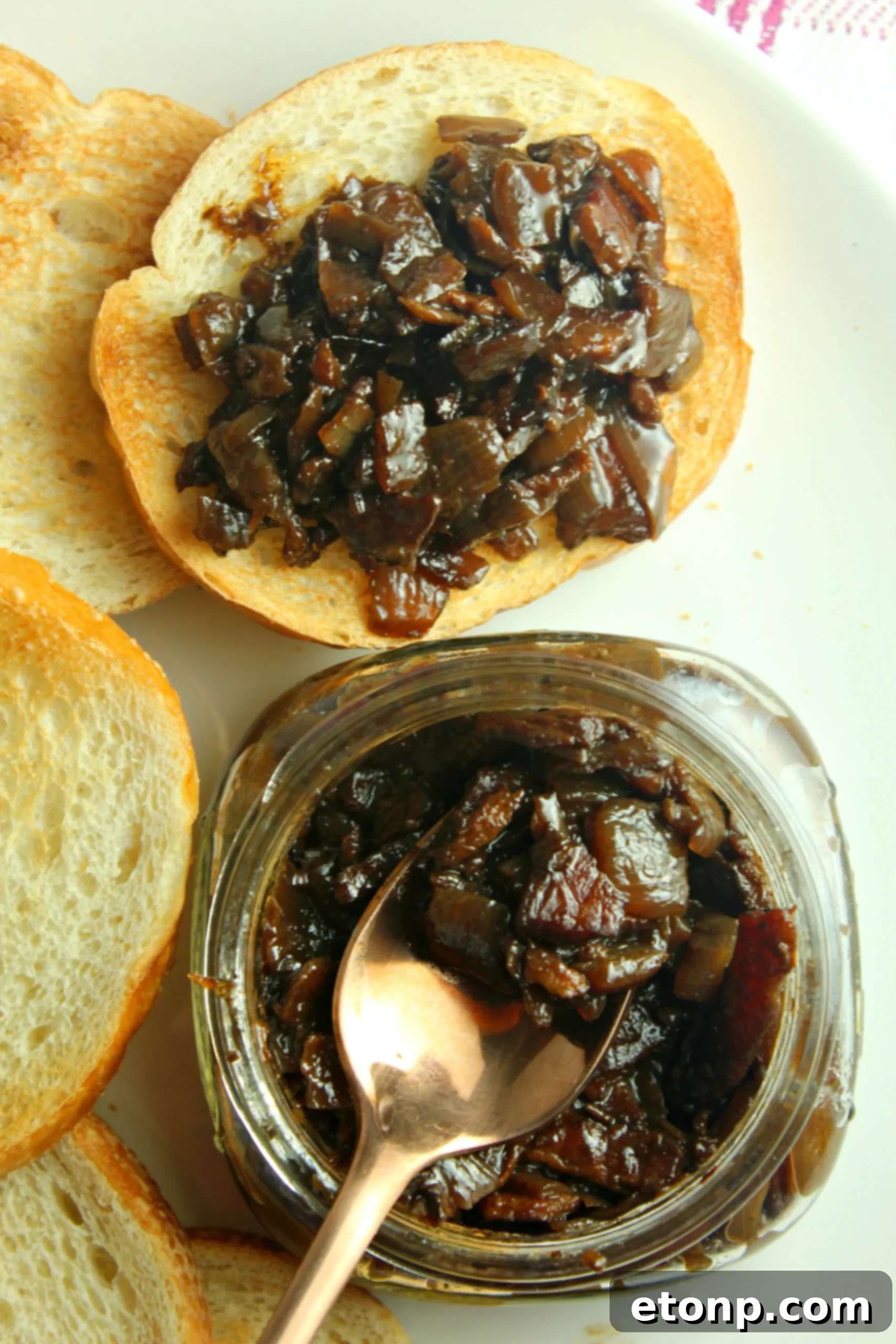 Prepared bacon jam stored in a glass jar inside a refrigerator, ensuring freshness