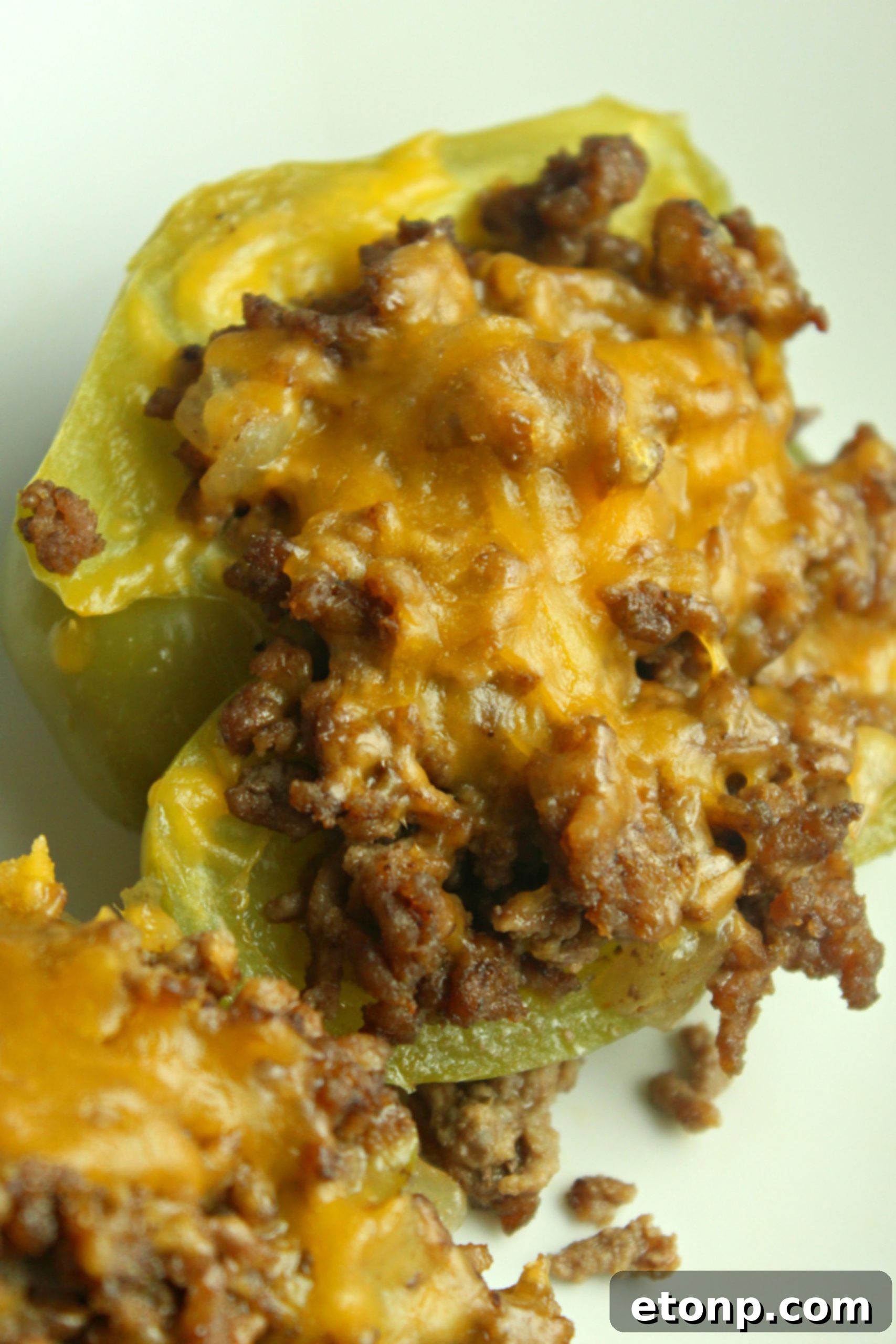 Philly Cheesesteak Pepper Boats 4 Overhead view of various fresh ingredients for stuffed peppers: ground meat, diced vegetables, and cheese.