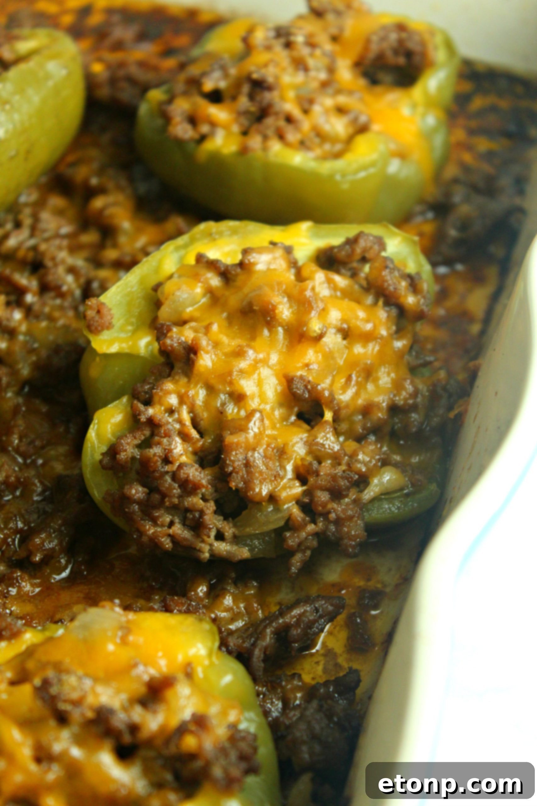 Philly Cheesesteak Pepper Boats 6 A baking dish filled with several stuffed bell peppers, baked to perfection.