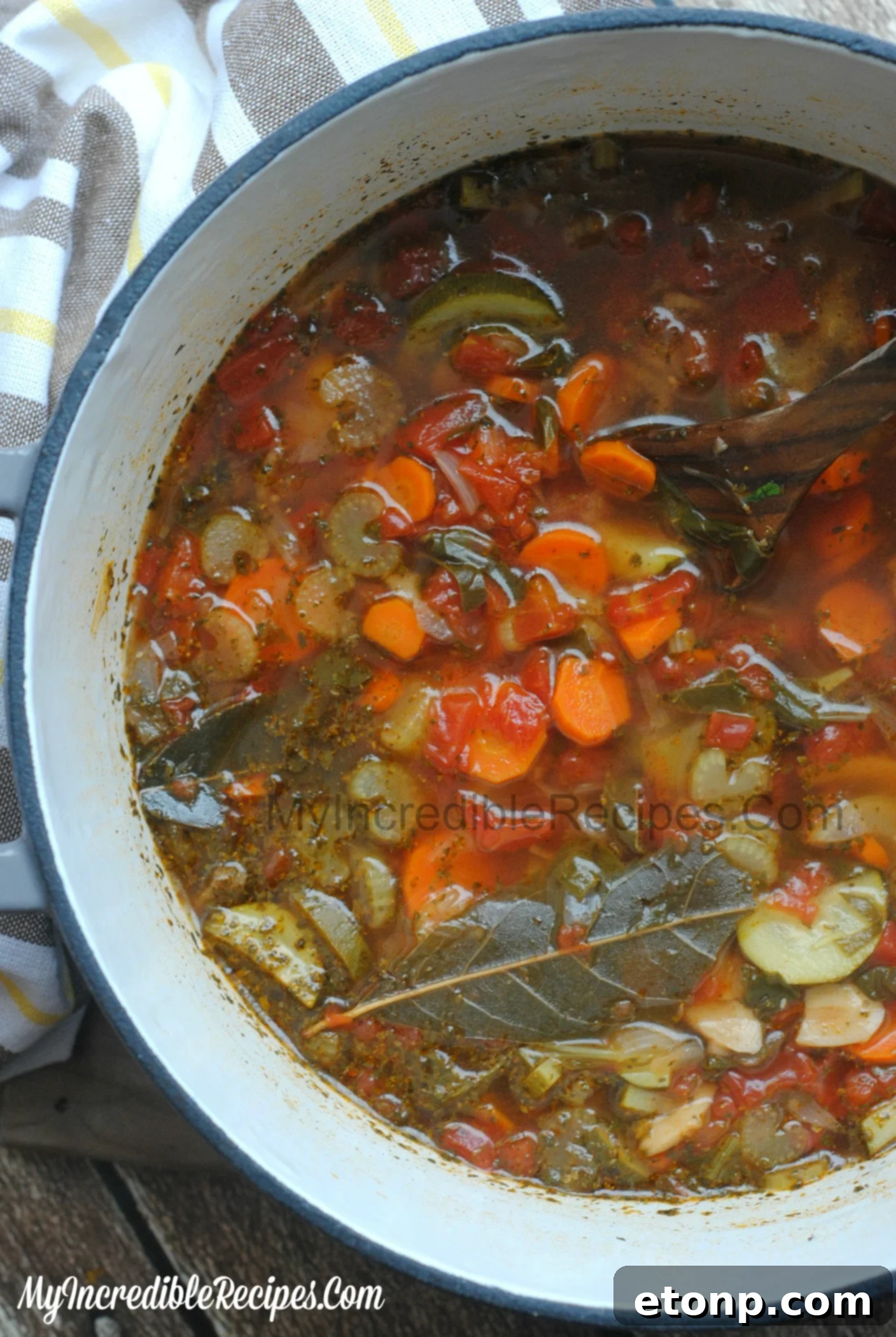 A comforting bowl of homemade chicken vegetable soup served with a slice of crusty bread, ready to be eaten.