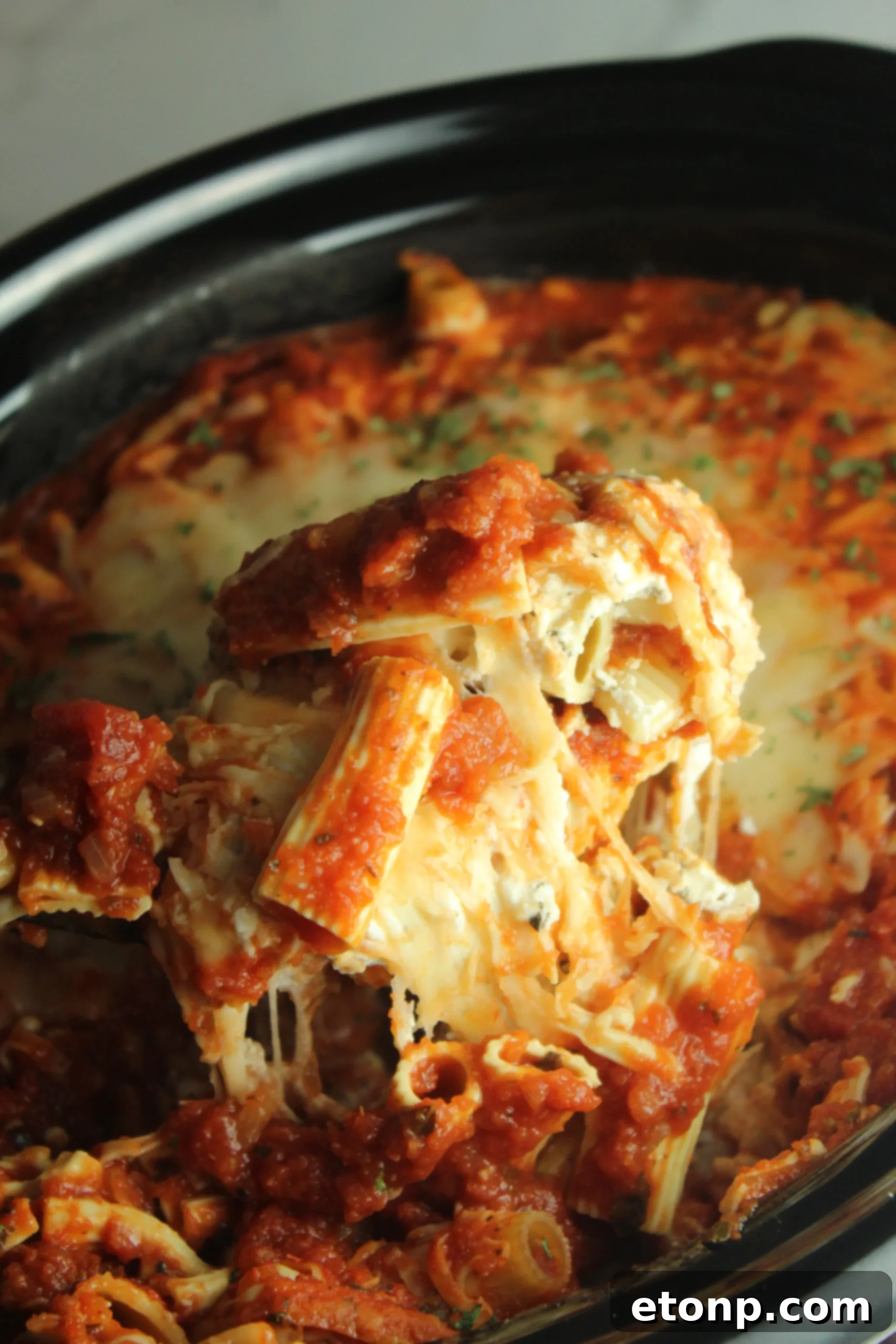 Set It and Forget It Cheesy Baked Ziti 4 Individual ingredients for slow cooker baked ziti, including cream cheese, sour cream, ricotta, garlic, and fresh basil.