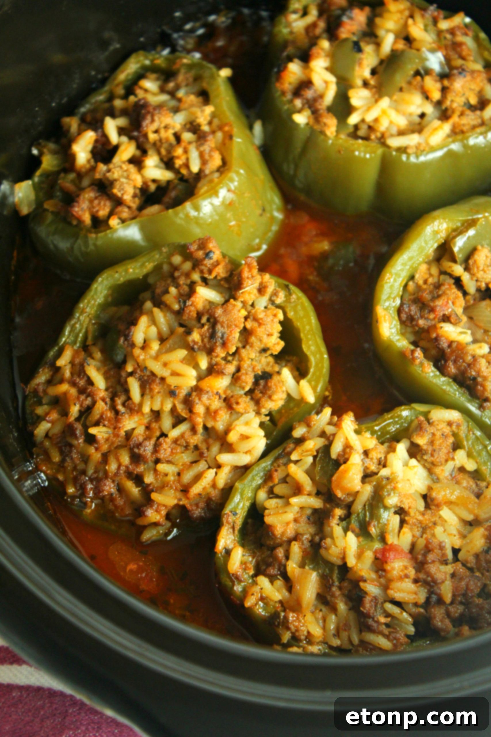 Effortless Slow Cooker Stuffed Peppers 7 A close-up shot of the raw, seasoned ground beef and rice mixture, ready to be spooned into the bell peppers.