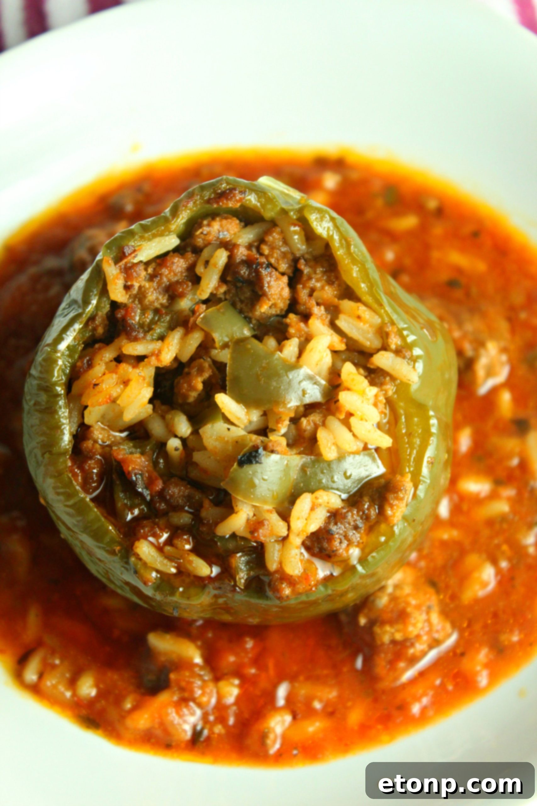 Effortless Slow Cooker Stuffed Peppers 9 A close-up of a single cooked stuffed bell pepper, removed from the slow cooker and ready to be served, highlighting its tender texture and rich sauce.
