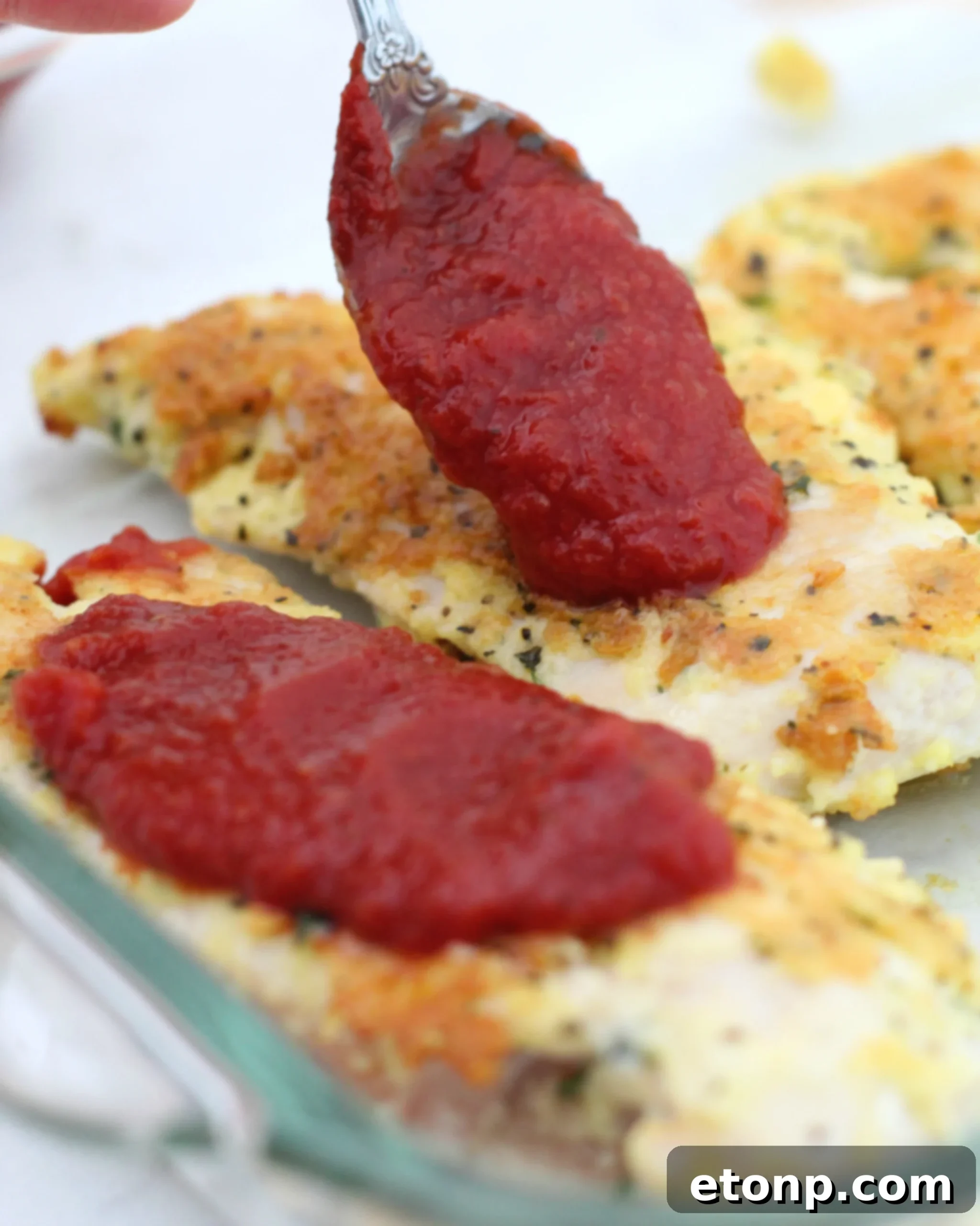 Keto Chicken Parmesan Perfection 3 Close-up of crispy, parmesan-crusted chicken breasts before baking, showcasing the perfect low-carb breading