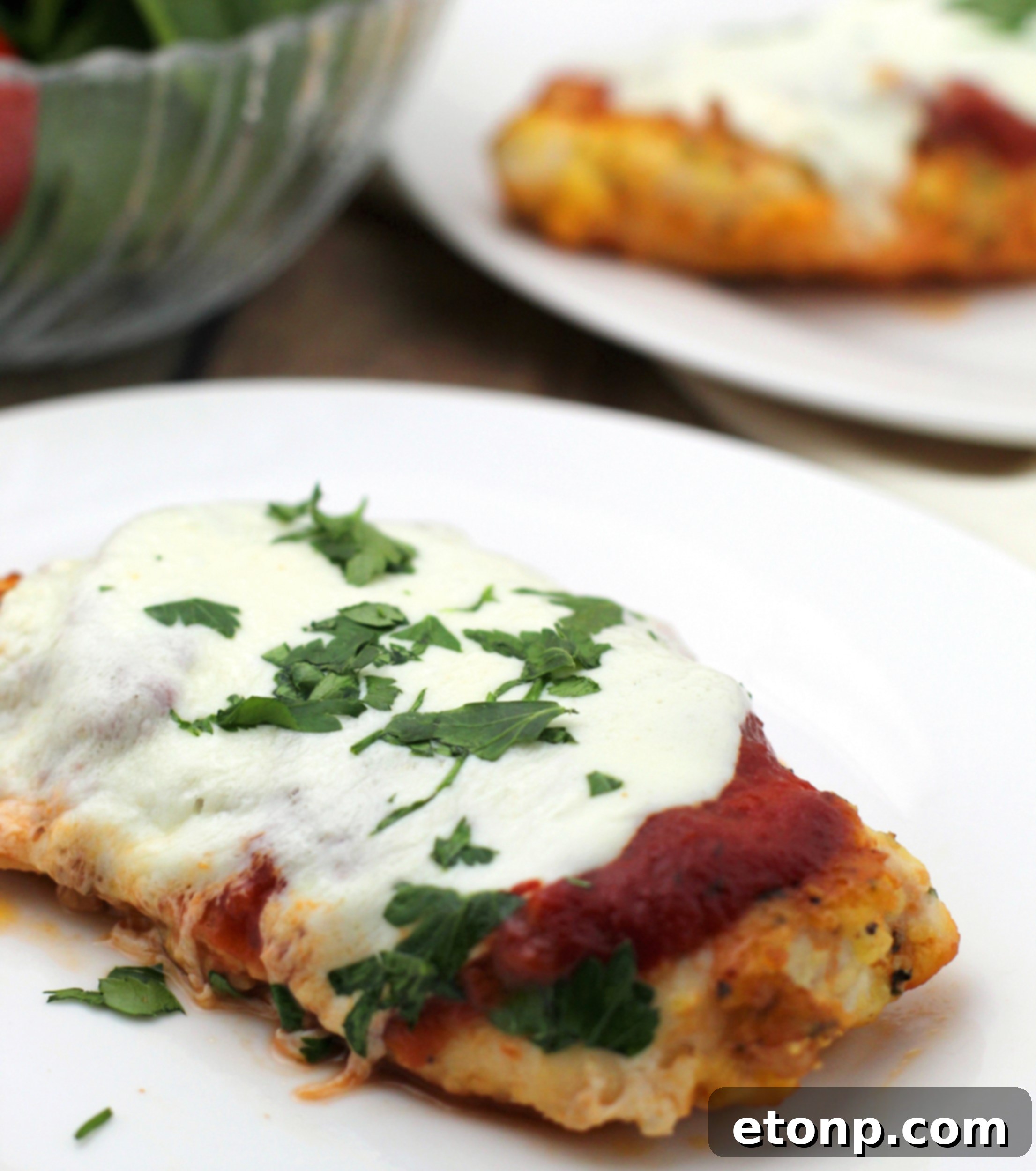 Keto Chicken Parmesan Perfection 5 Overhead view of a baking dish filled with several pieces of golden Keto Chicken Parmesan, bubbling with cheese and sauce