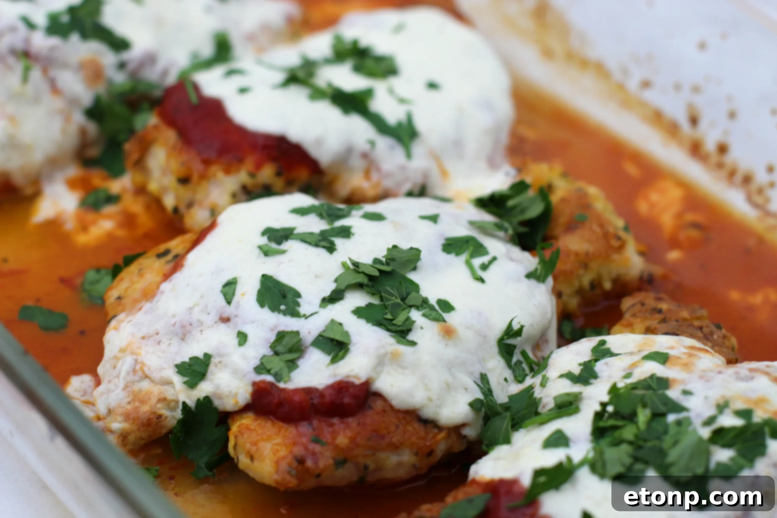 Keto Chicken Parmesan Perfection 7 Finished Keto Chicken Parmesan served in a white bowl, garnished with basil, ready to be eaten