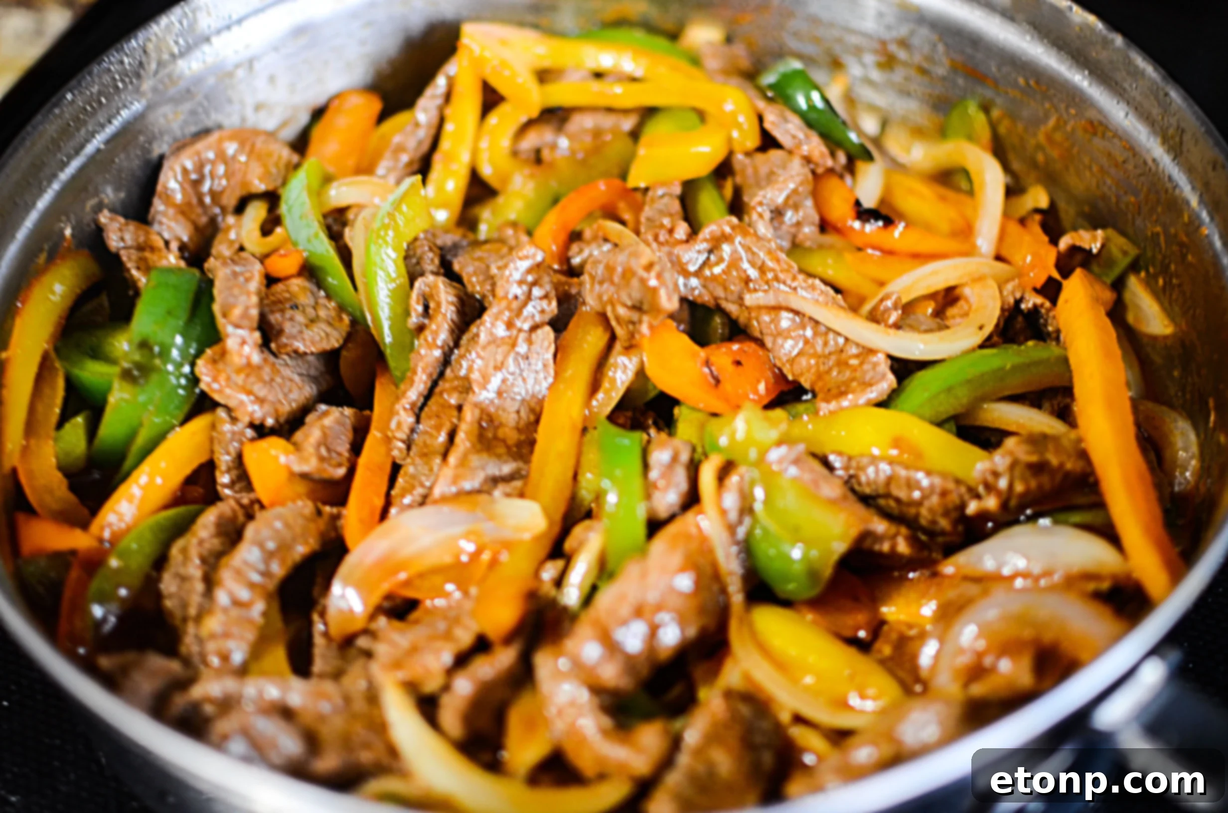 A serving of the low carb Philly cheesesteak skillet alongside a fresh green salad, highlighting a healthy meal option.