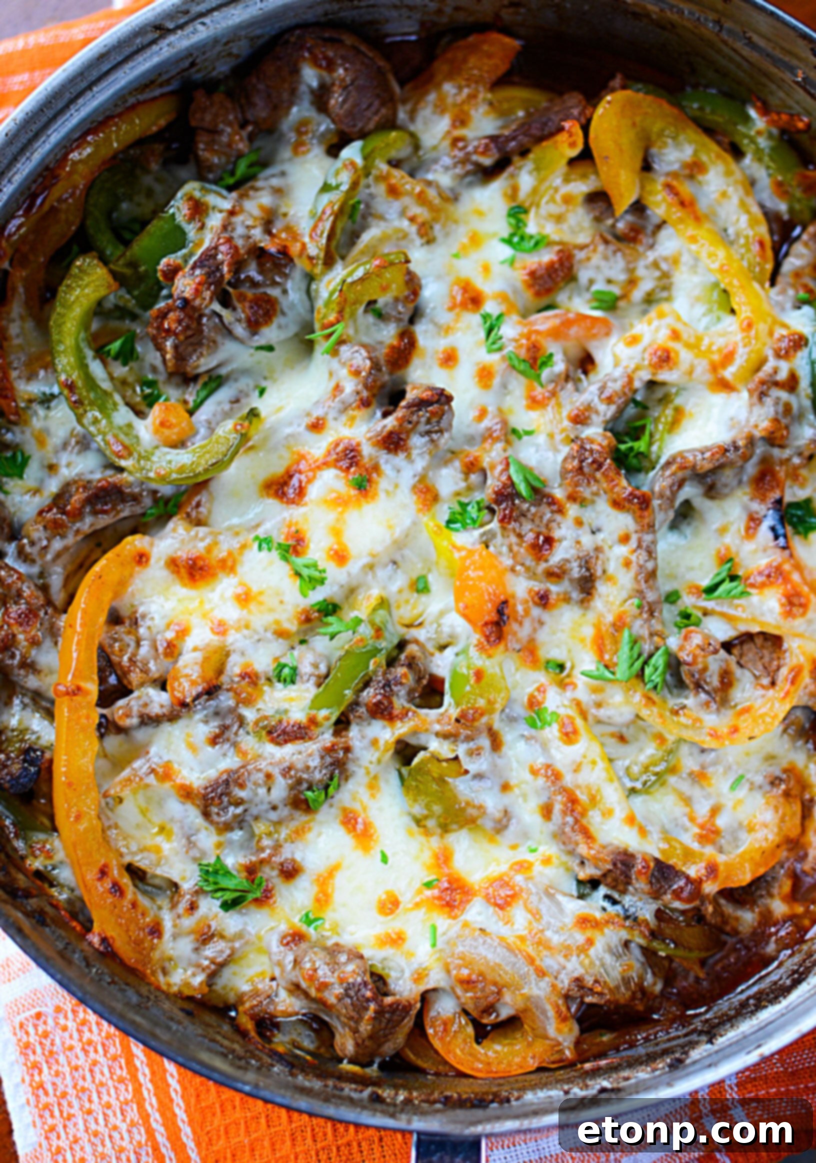 A wide shot of the low carb Philly cheesesteak skillet on a stovetop, capturing the overall presentation of the meal.