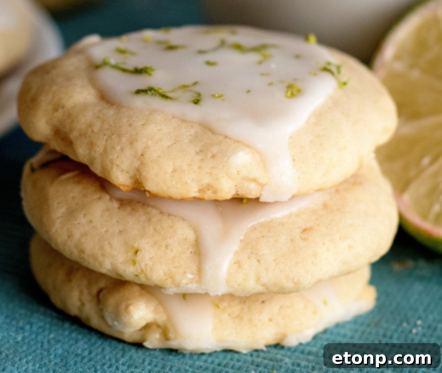 Delicious Key Lime Pie Cookies with lime zest and glaze on a cooling rack