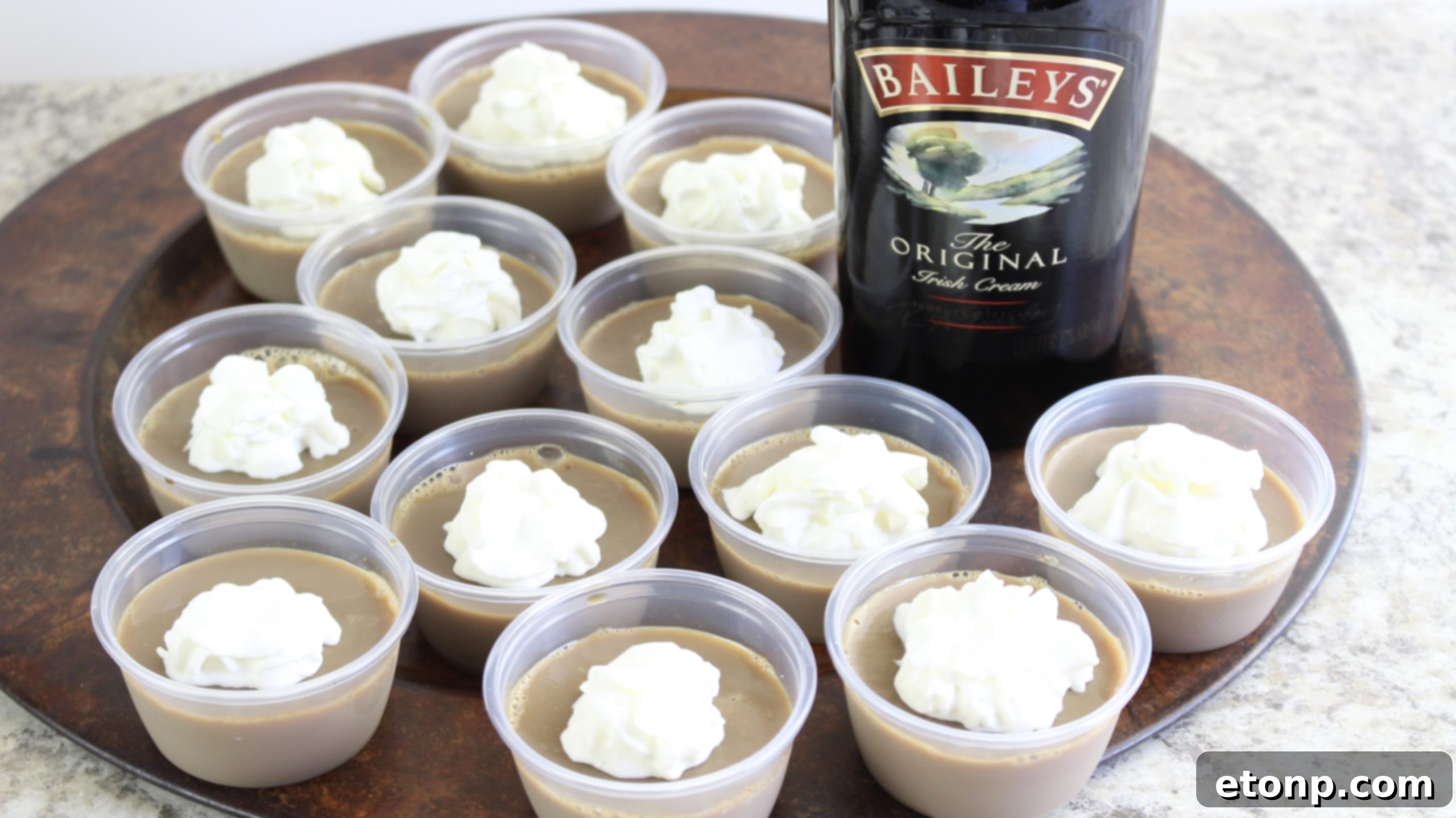 Several Baileys Irish Cream Jello Shots lined up, emphasizing their uniform and appealing appearance.