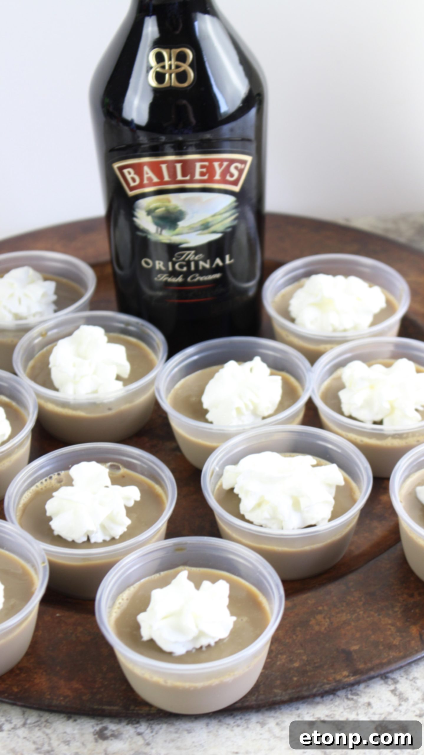 A collection of Baileys Irish Cream Jello Shots on a white background, inviting guests to enjoy.