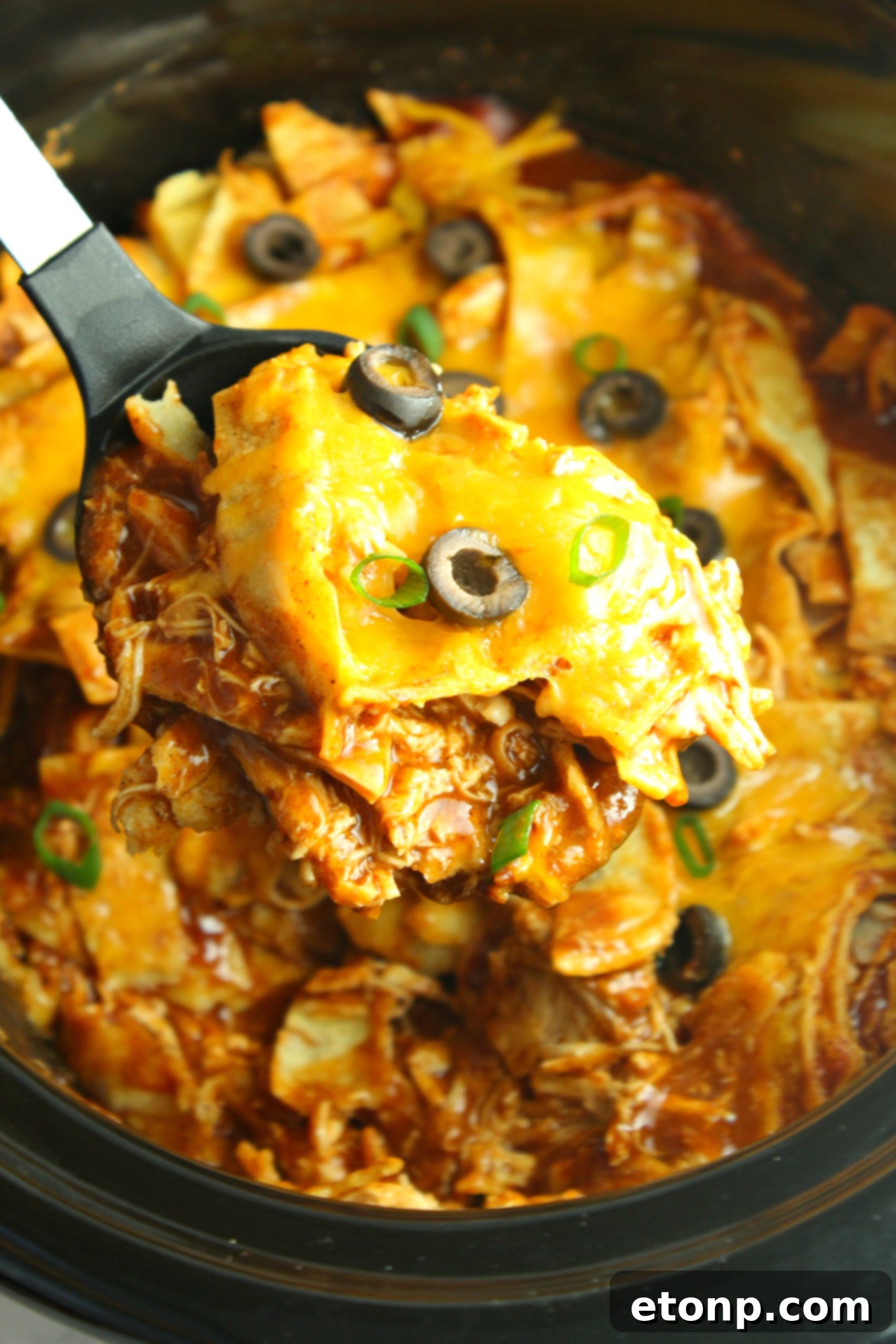 Top view of Slow Cooker Chicken Enchilada Casserole, showcasing melted cheese and vibrant ingredients