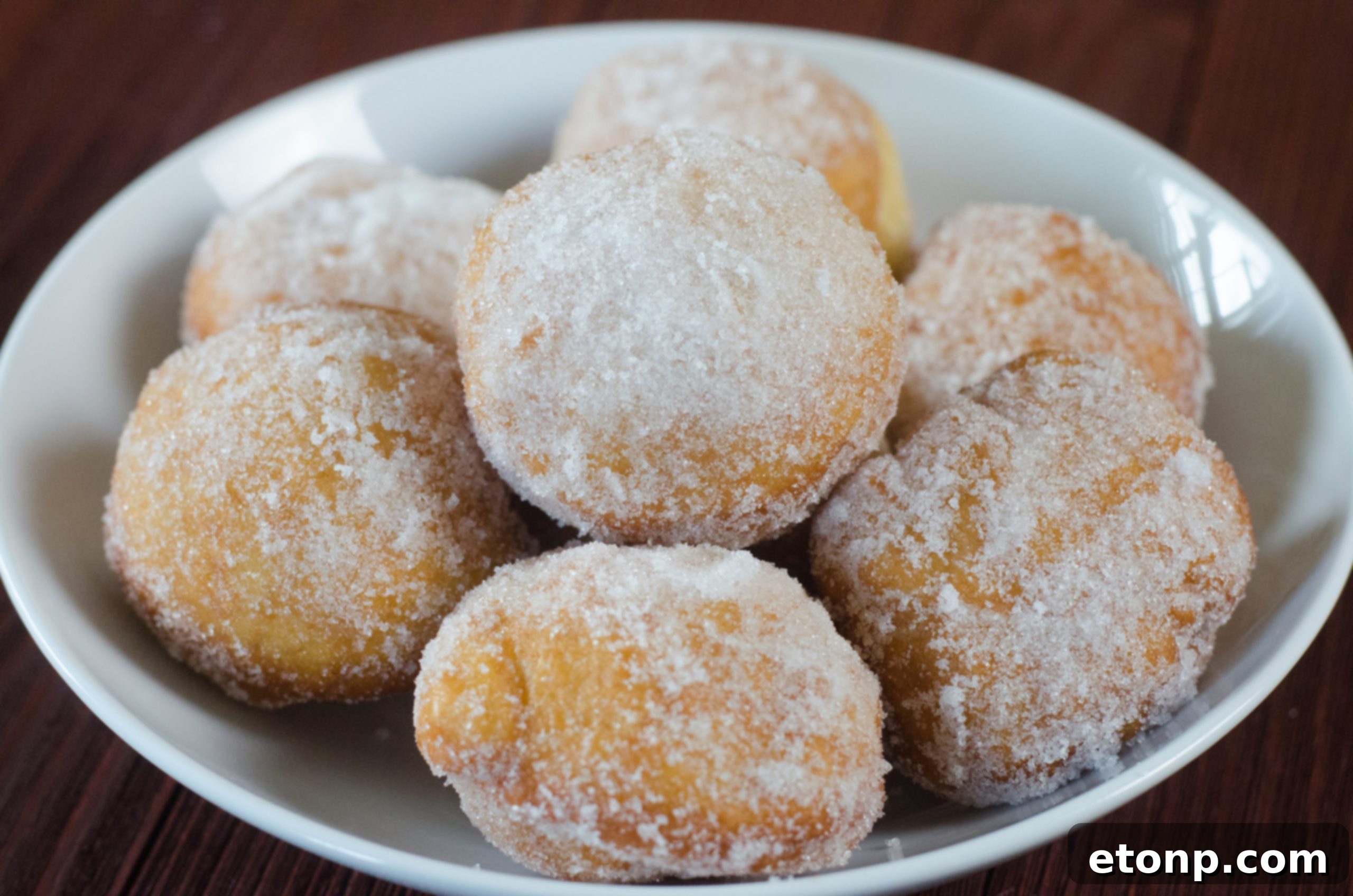 A stack of several Chinese sugar donuts, showing their height and fluffy appearance, ready for enjoyment.