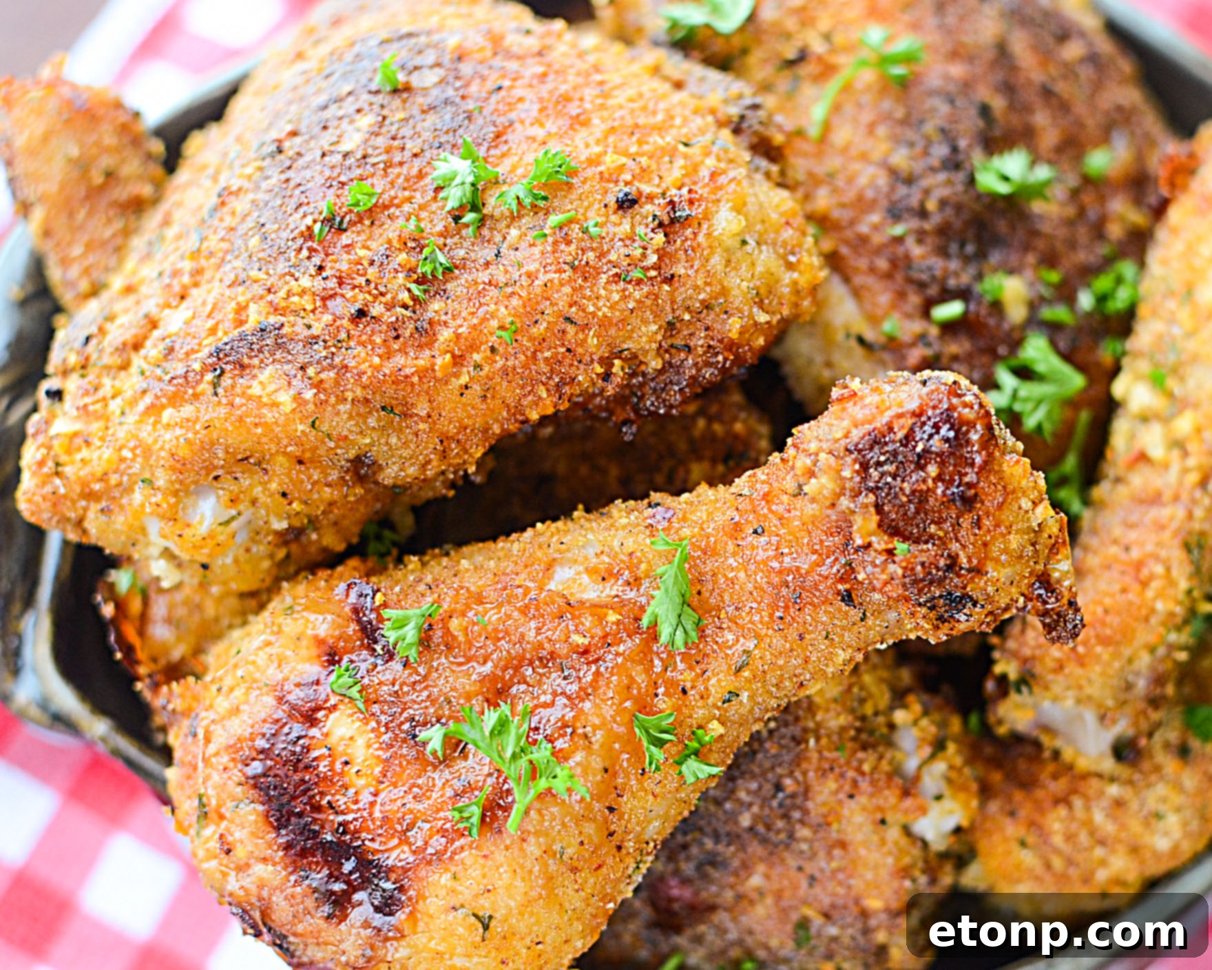 Several pieces of Taco Fried Chicken arranged artfully on a serving platter, garnished with fresh herbs