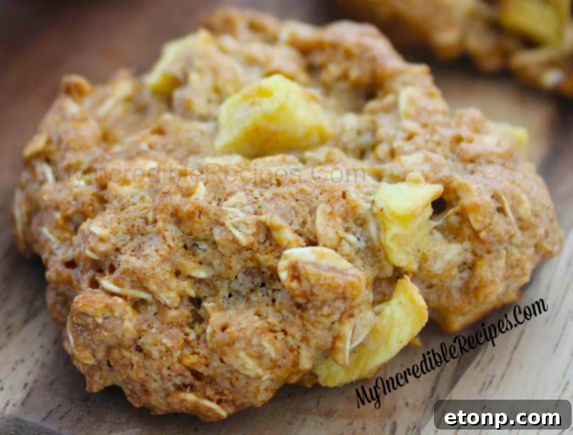 Hand reaching for a freshly baked apple cinnamon cookie