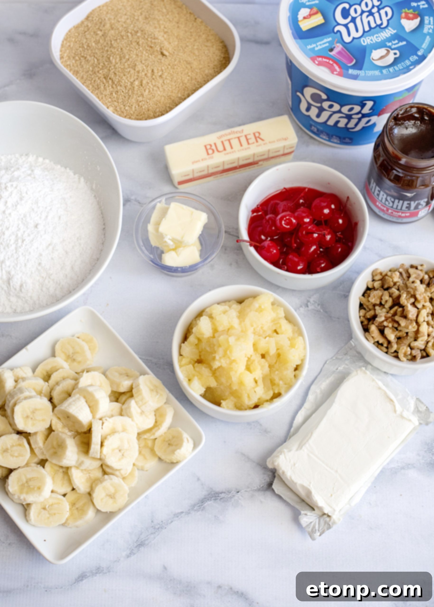 Close-up shot of the layered No-Bake Banana Split Dessert showing cream, bananas, and pineapple