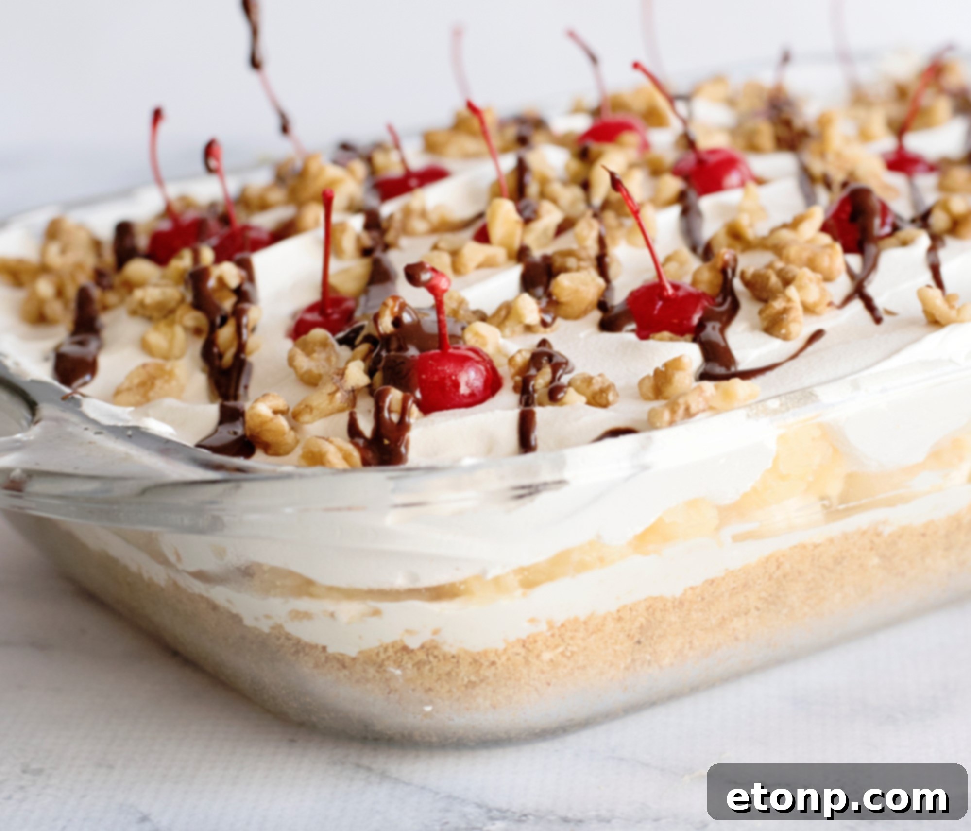 Single serving of No-Bake Banana Split Dessert with a spoon