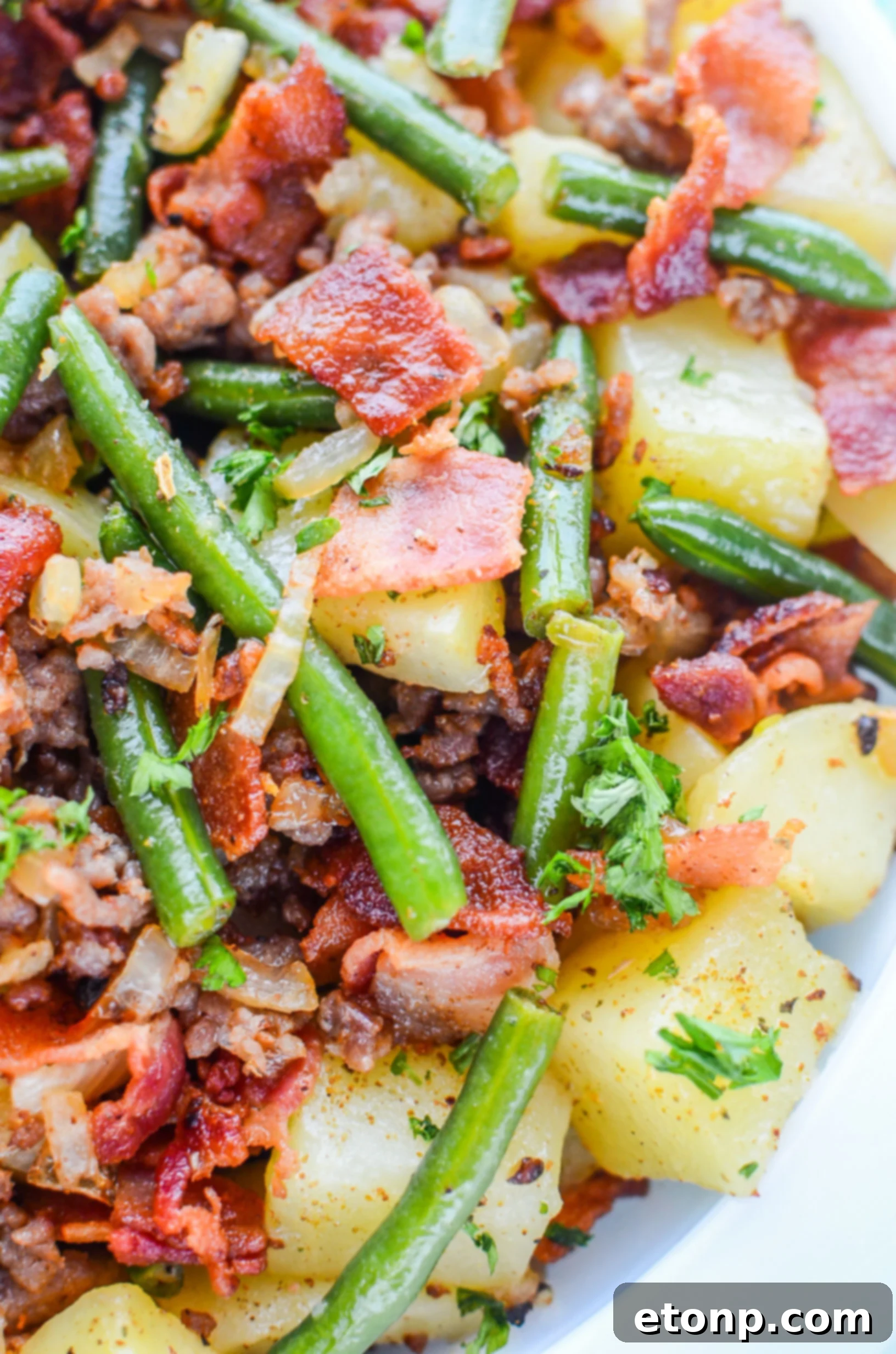 Sizzling thick-cut bacon cooking in a skillet for a rich base flavor