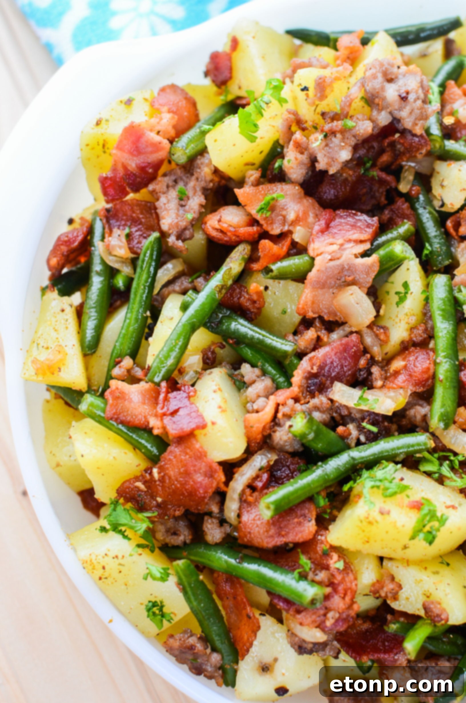 A serving of comforting Southern Sausage, Potatoes, and Green Beans in a rustic bowl