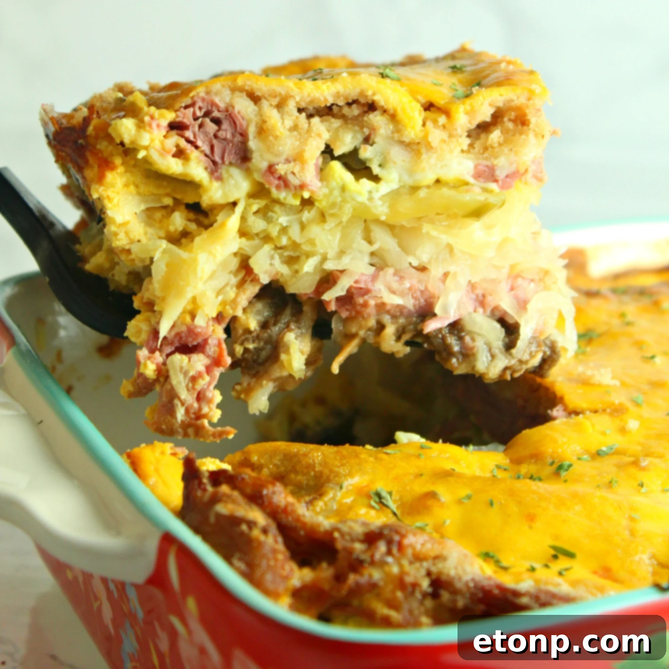 A delicious baked Reuben casserole, golden brown and bubbling with melted Swiss cheese, served in a casserole dish.