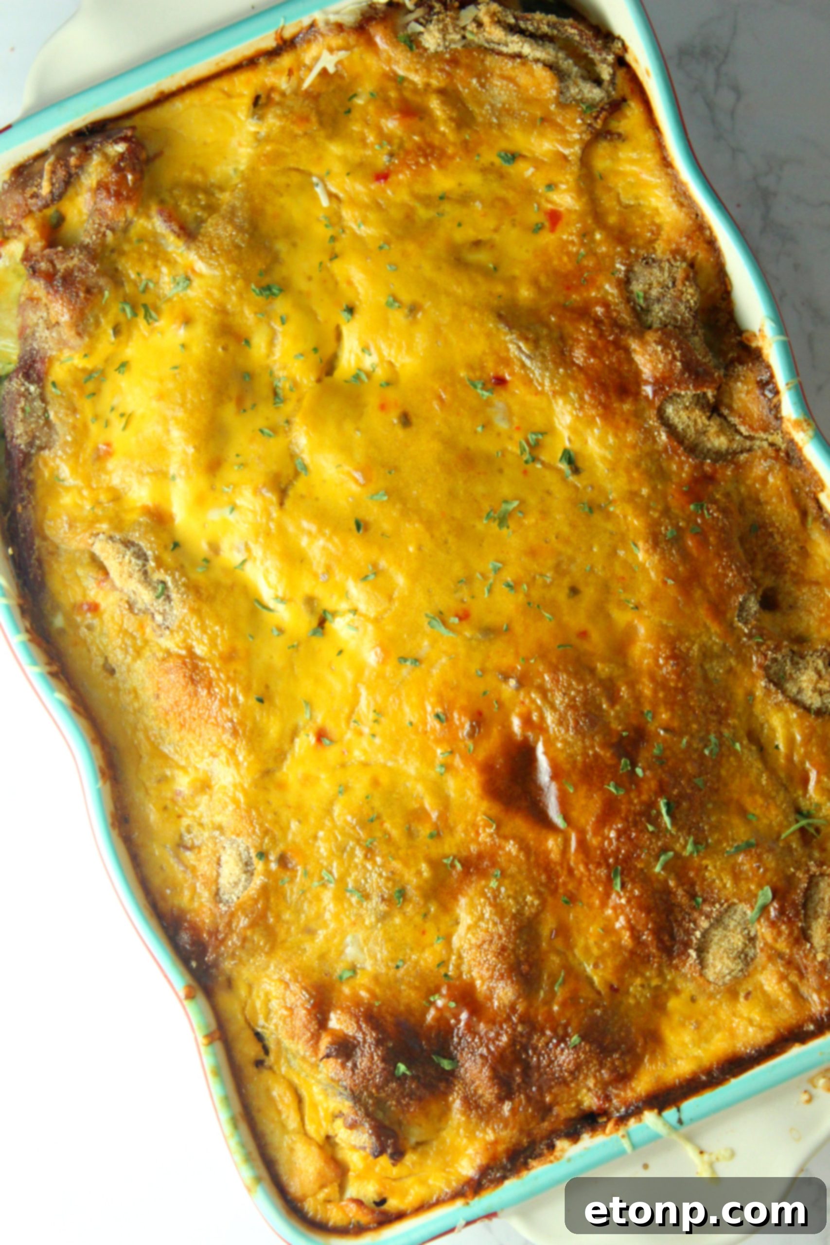 Close-up of a generous scoop of Baked Reuben Casserole, showcasing layers of rye bread, corned beef, sauerkraut, and melted cheese.