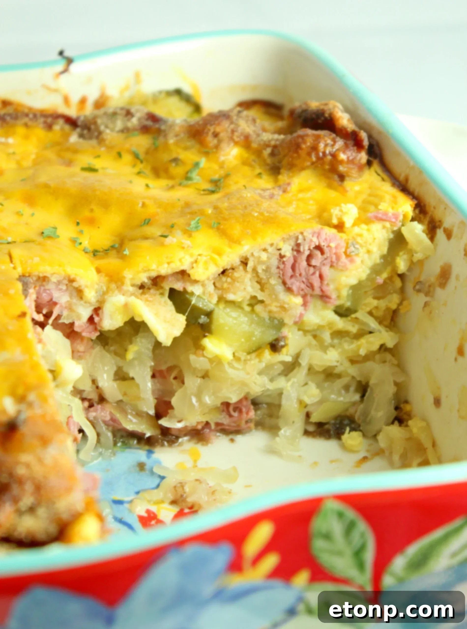 A generous layer of shredded cooked corned beef spread over the rye bread in a casserole dish.
