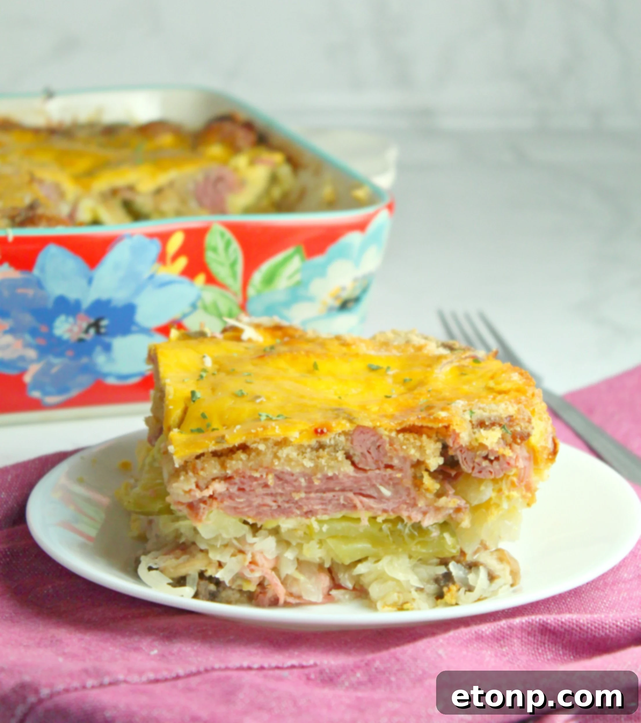 A close-up shot of the finished Baked Reuben Casserole, showcasing its golden-brown crust, melted cheese, and comforting layers.