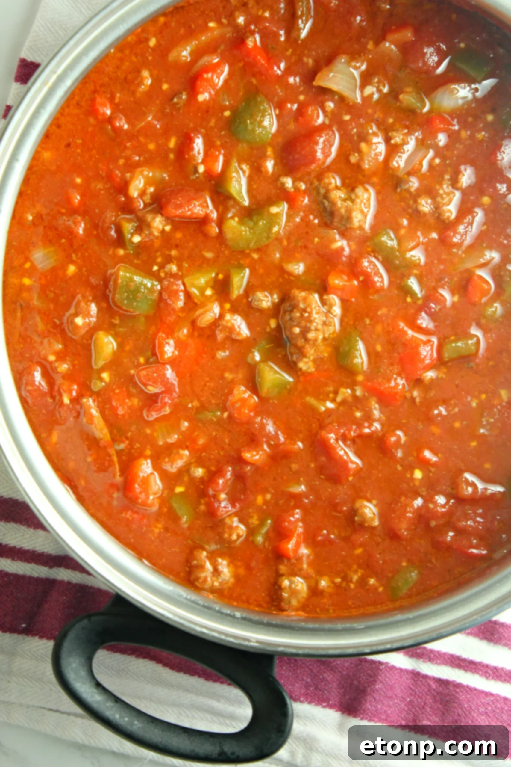 Homestyle Stuffed Pepper Stew 4 A bowl of hot stuffed pepper soup garnished with fresh herbs, ready to be enjoyed.