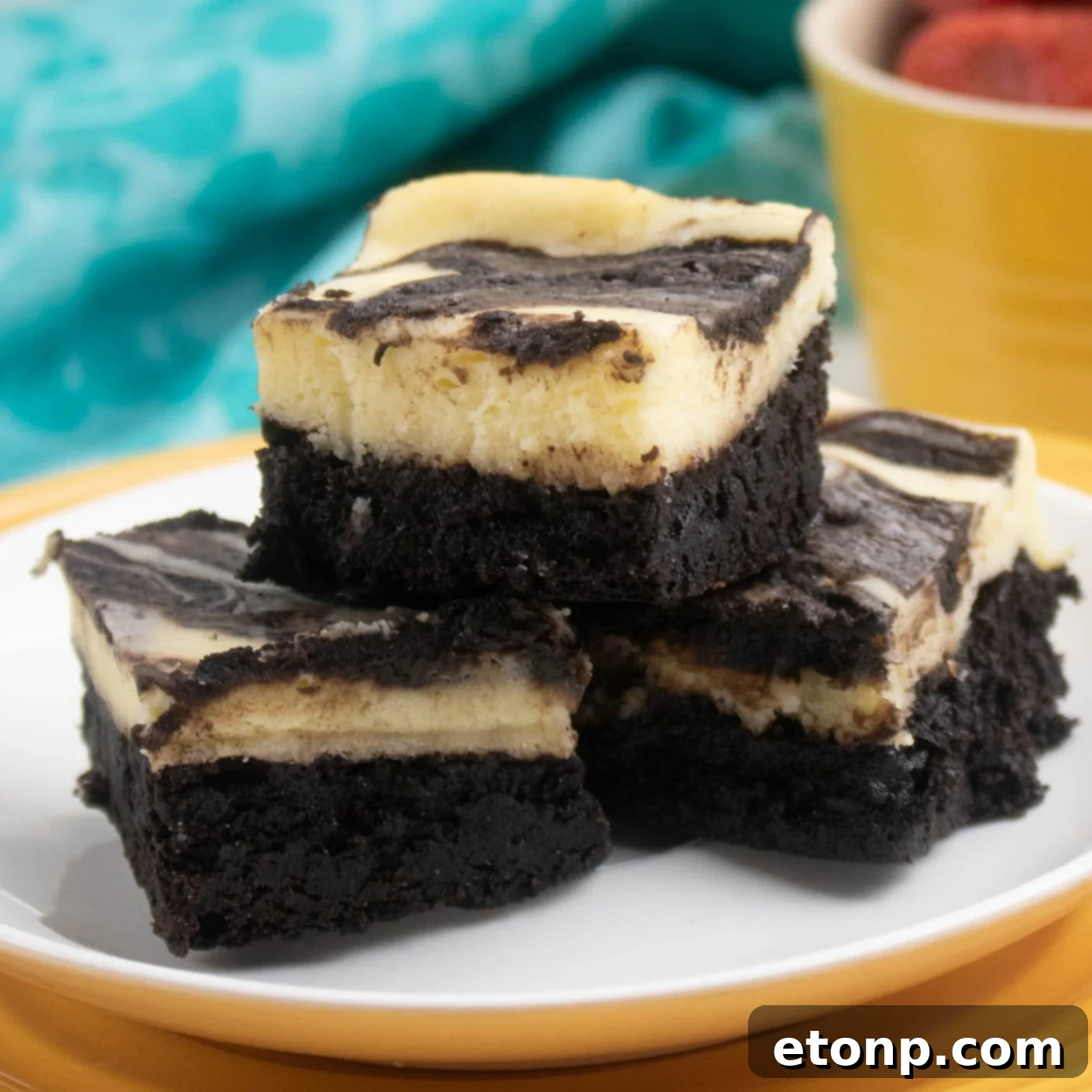 Homemade Cheesecake Swirl Brownies 2 A perfectly baked cheesecake swirl brownie, showcasing the rich chocolate brownie base and the creamy, distinct cream cheese swirl on top.