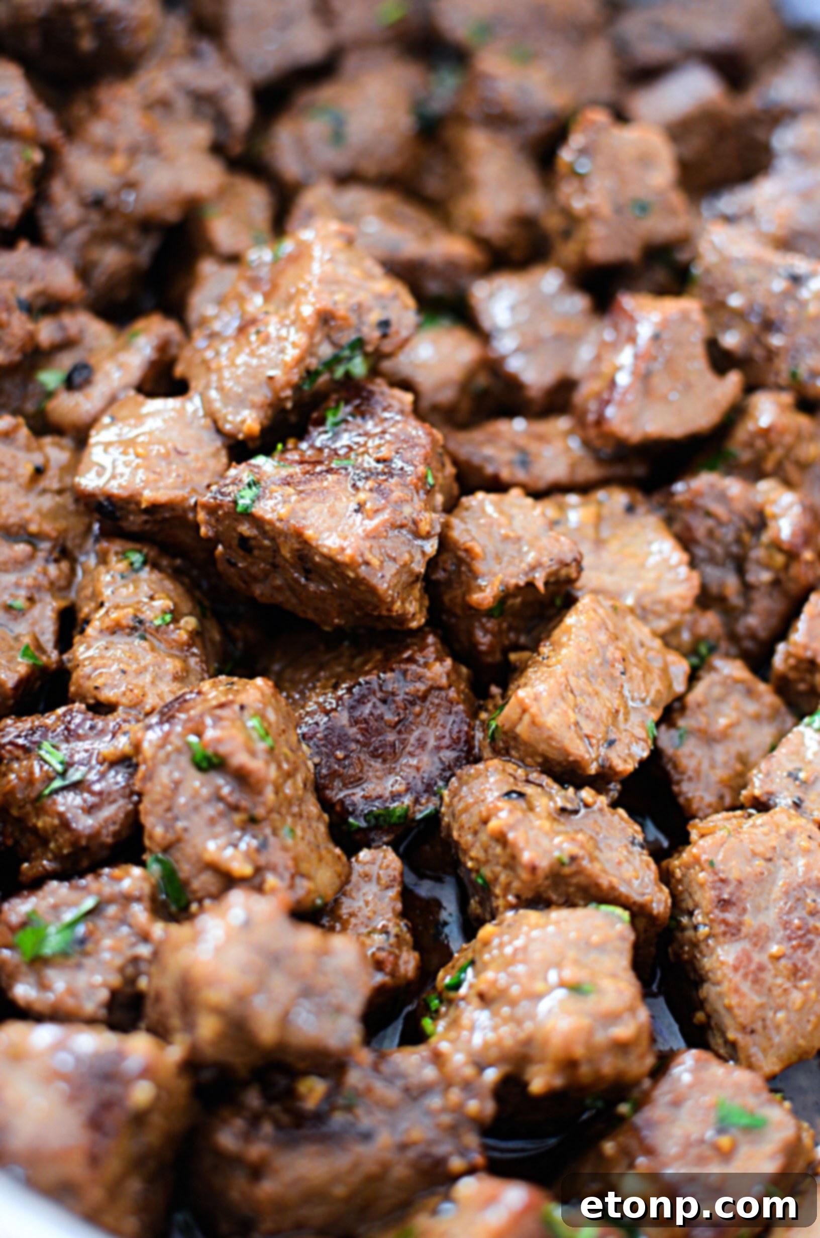 Uncooked sirloin steak, cubed and ready for seasoning.