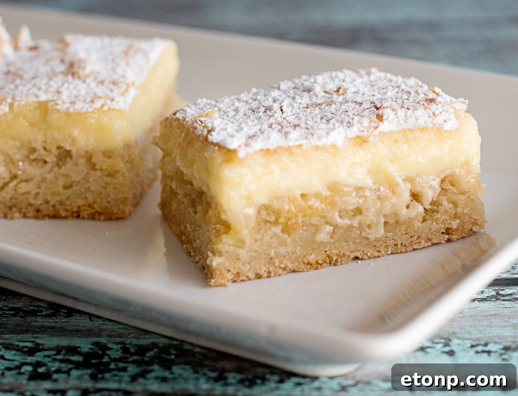A full pan of Ooey Gooey Butter Cake, golden and ready to be sliced.