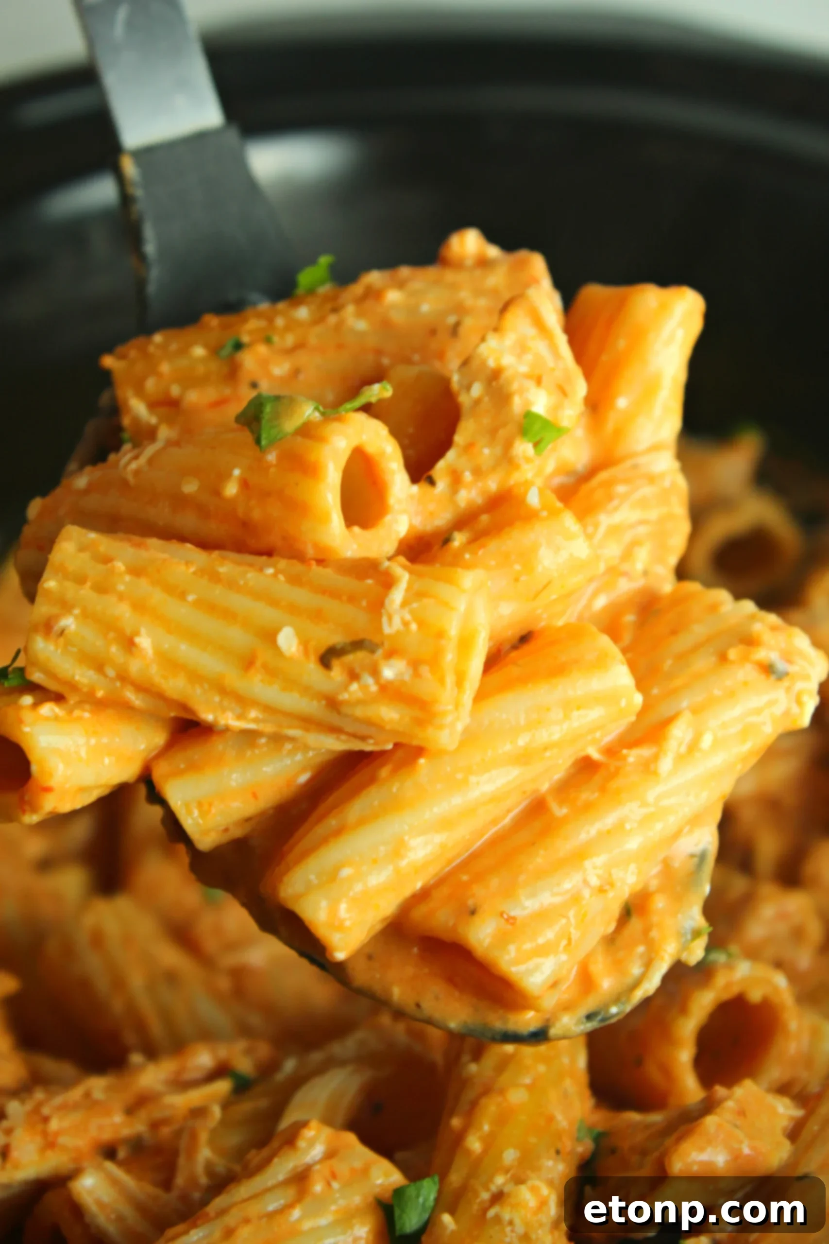 Close up of a slow cooker with chicken and sauce simmering