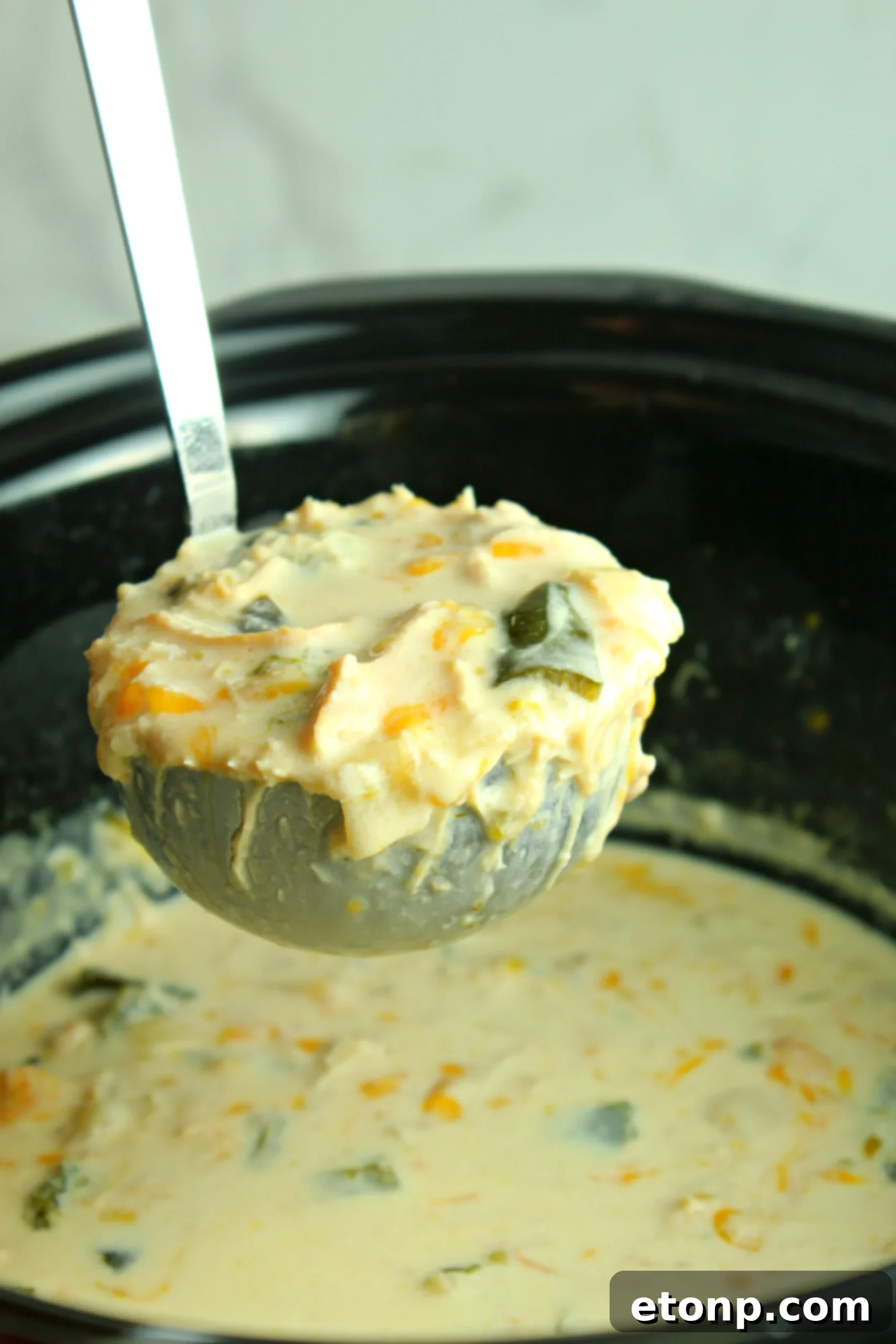 Delicious Slow Cooker Chicken Chile Rellenos Soup garnished with fresh cilantro, ready to be served