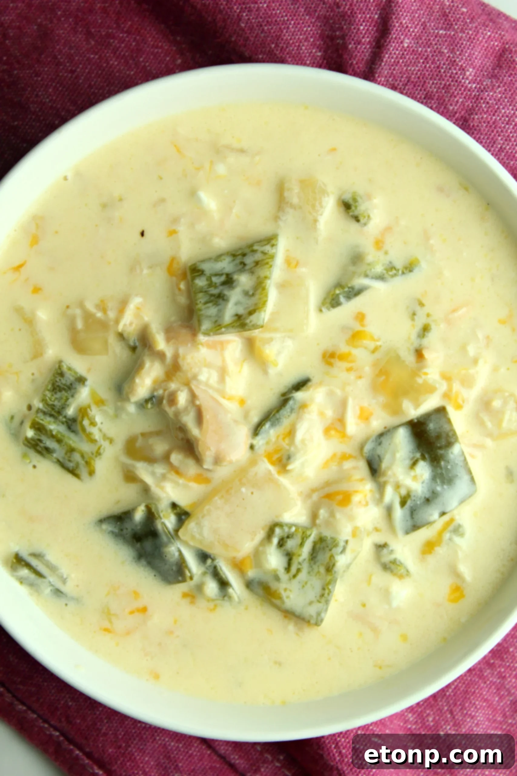Bowl of Slow Cooker Chicken Chile Rellenos Soup with a vibrant green color, highlighting the freshness of poblano peppers