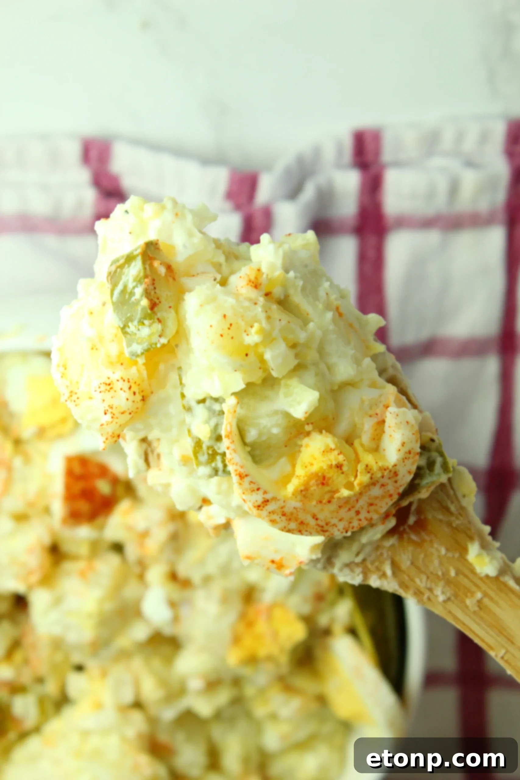 A close-up of the creamy dressing being mixed in a separate bowl, highlighting its smooth texture.