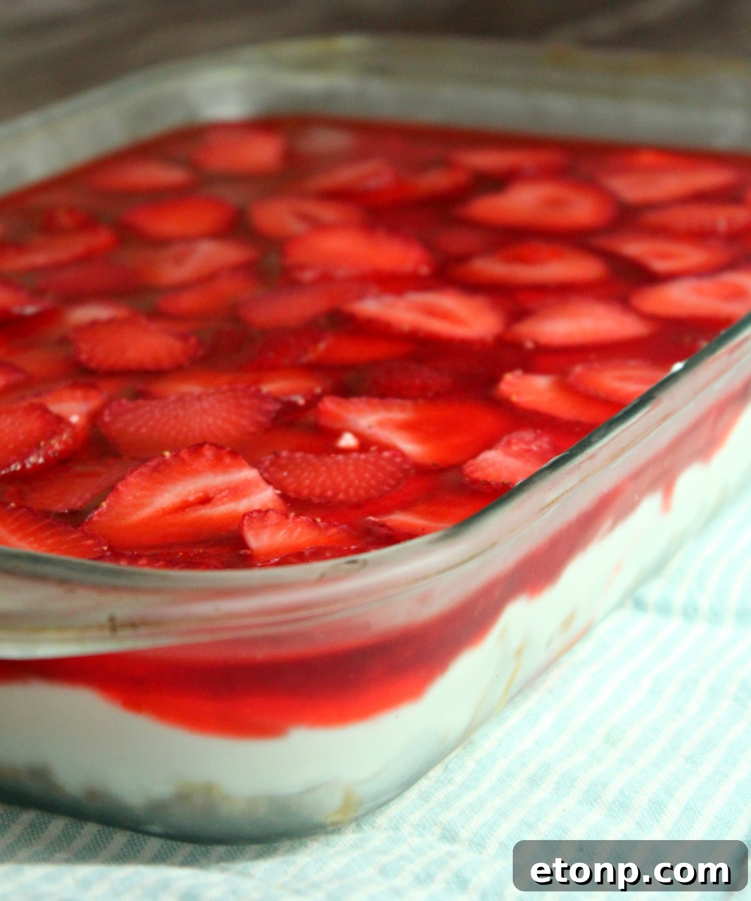 A freshly prepared Strawberry Pretzel Salad, ready to be chilled and served at a gathering.